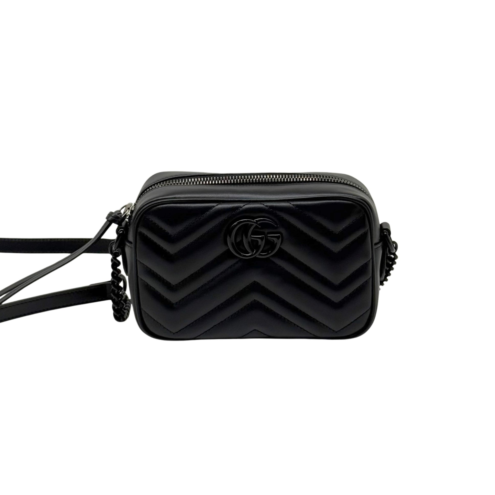Black leather mini crossbody bag with chevron quilting and GG logo, centered front view.