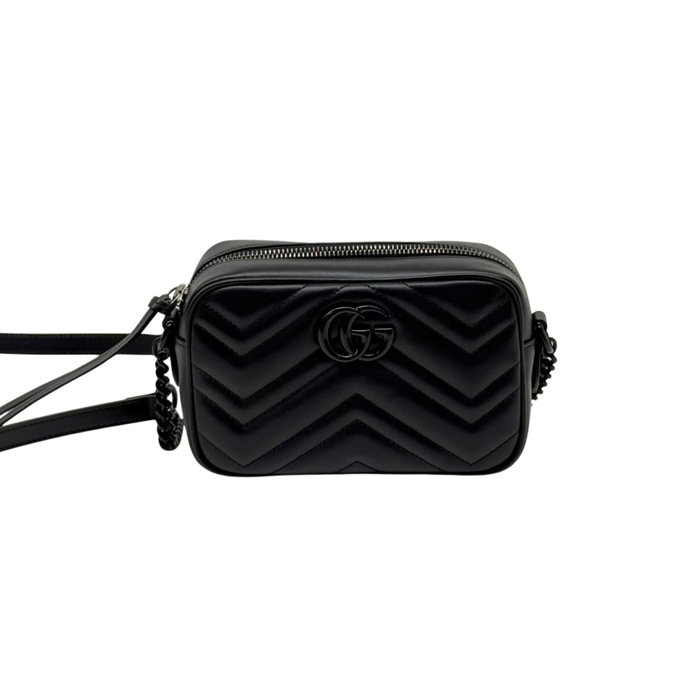 Black leather mini crossbody bag with chevron quilting and GG logo, centered front view.
