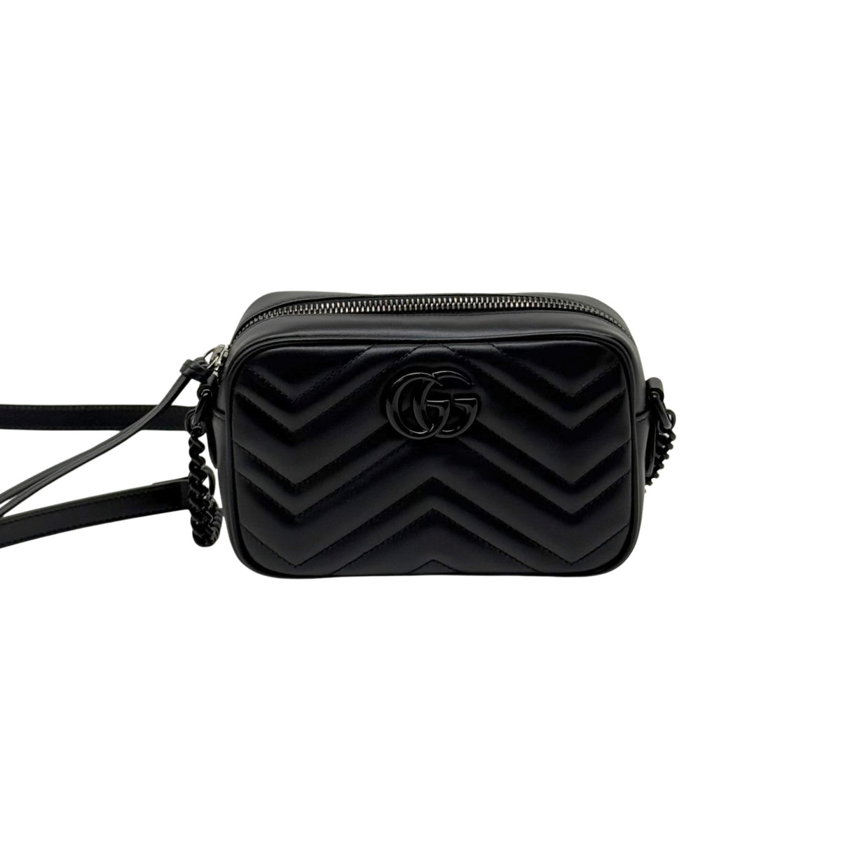 Black leather mini crossbody bag with chevron quilting and GG logo, centered front view.