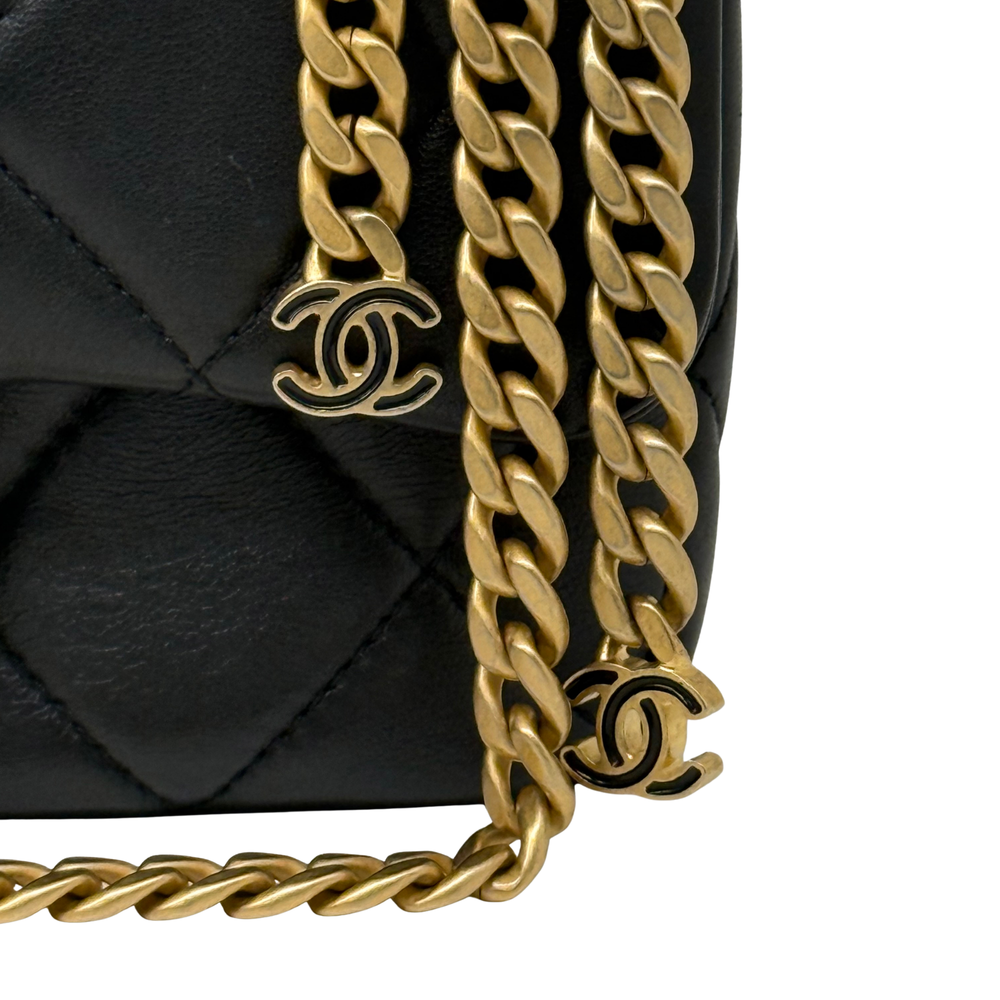 Black leather flap with gold-tone chain charms and circular CC logo accents