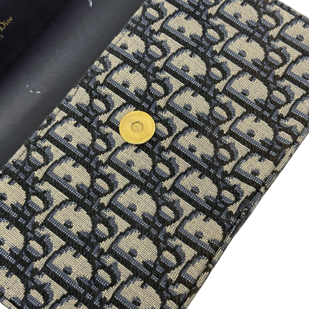 Dior monogram bag corner with gold snap button and woven canvas texture