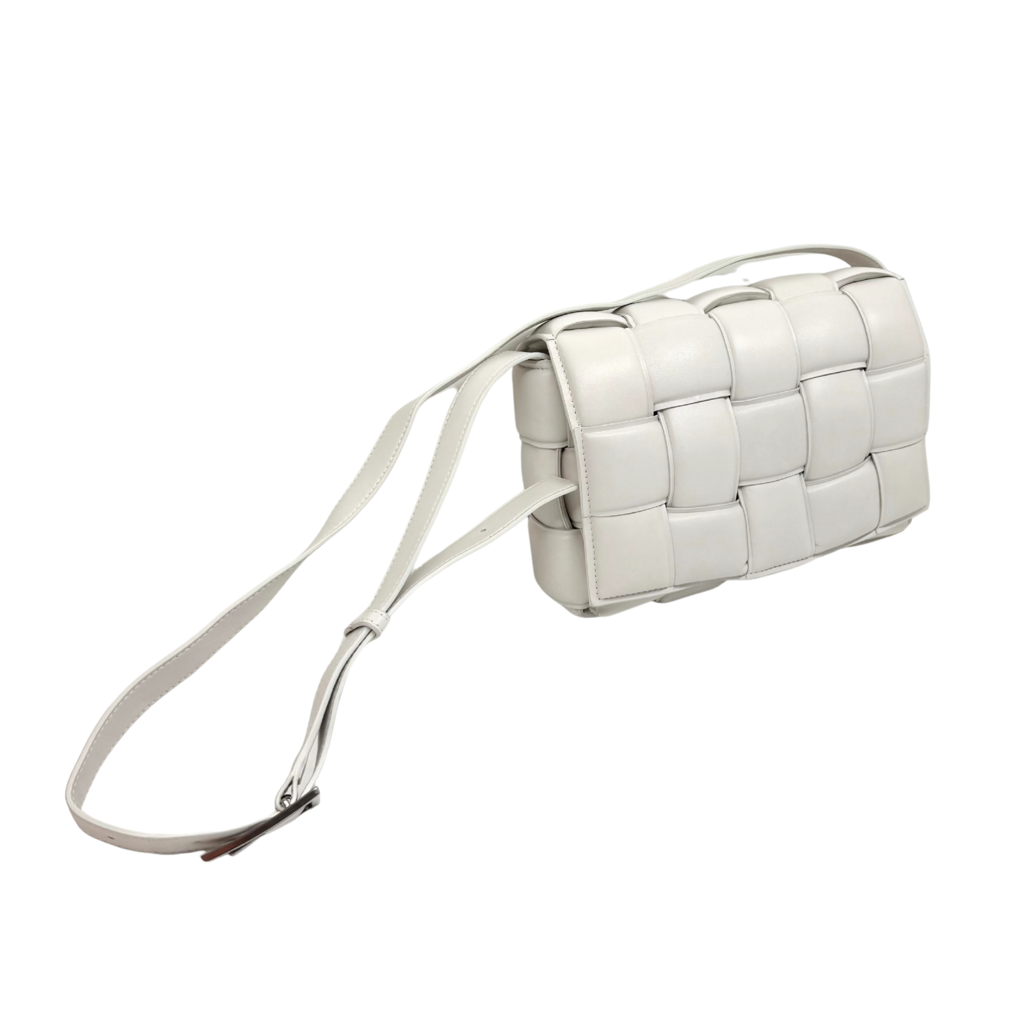 White leather crossbody bag in a compact woven-style design with shoulder strap