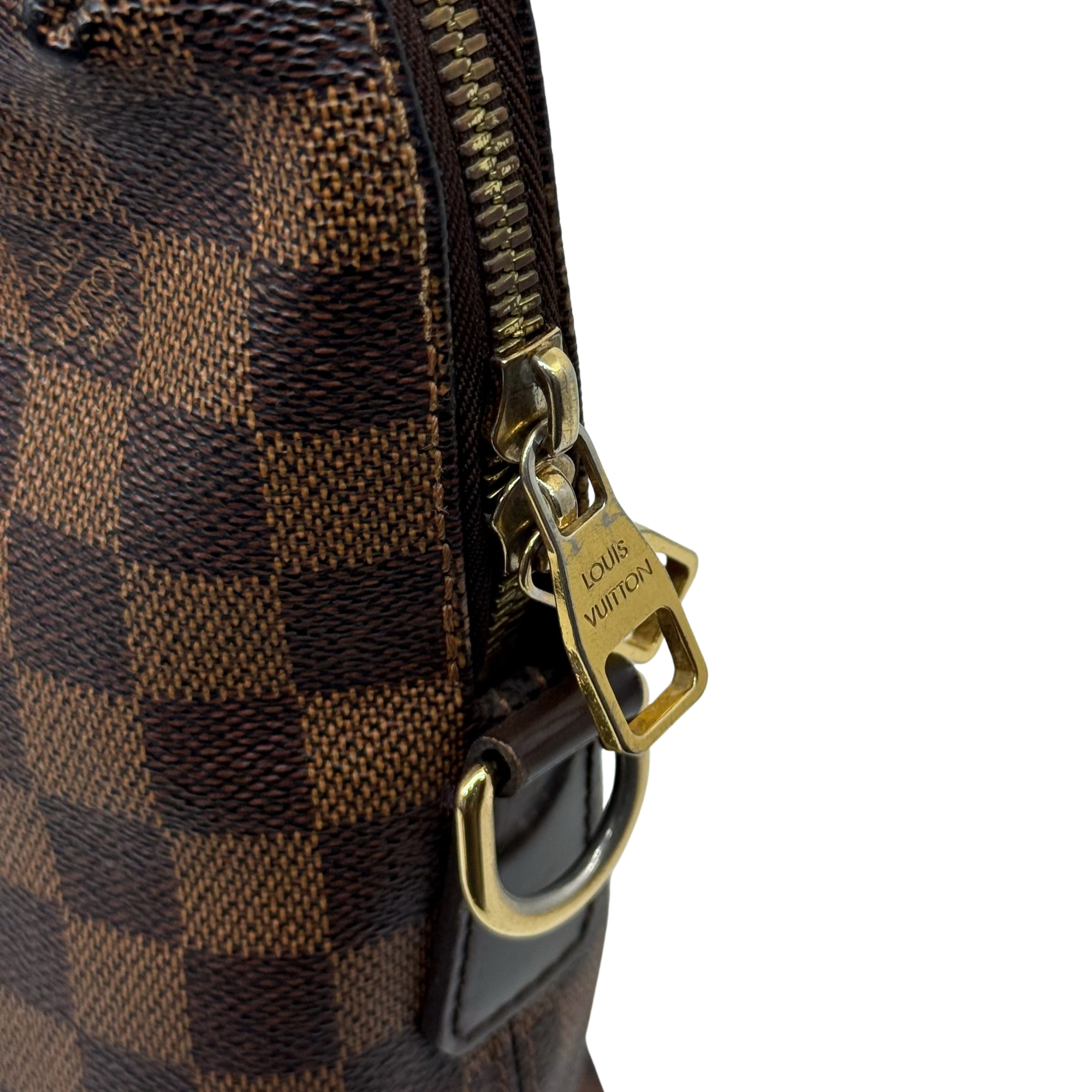Pre-owned Louis Vuitton checkered handbag zipper close-up with metal pull and leather tab