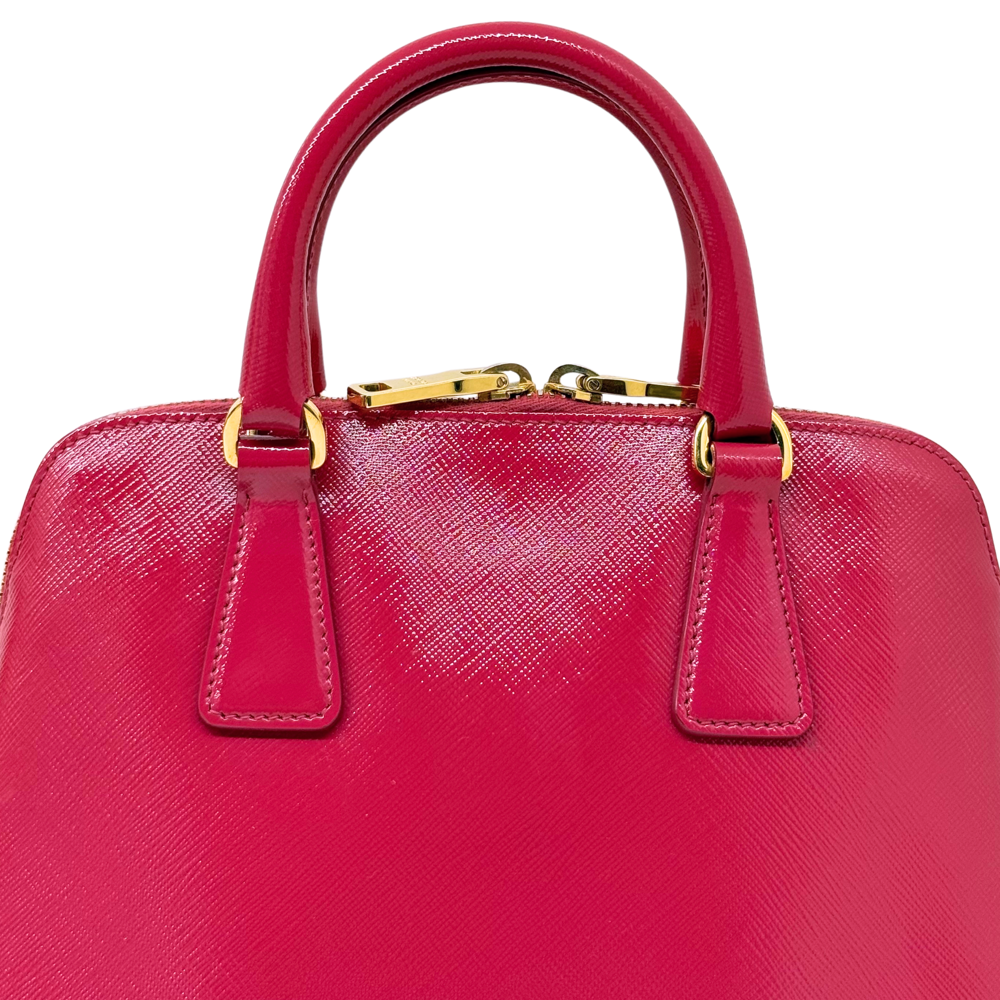 Prada pink handbag top view with two handles and gold clasp hardware