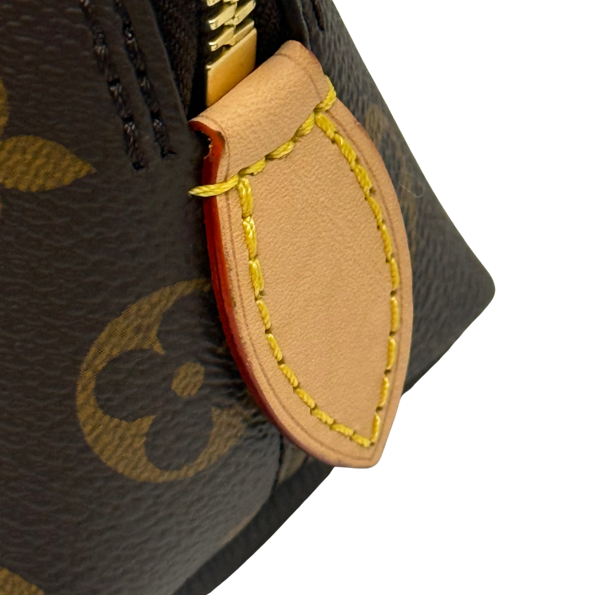 Monogram bag corner with leather tab and bright yellow stitched edge