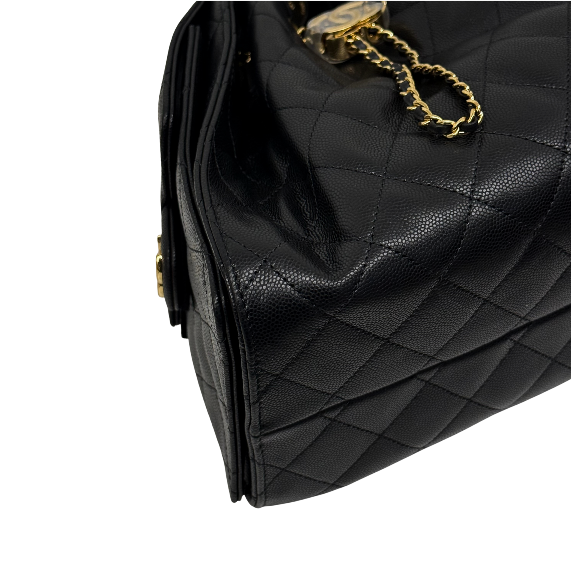 Black quilted handbag side panel with gold chain detail and fringe tassel