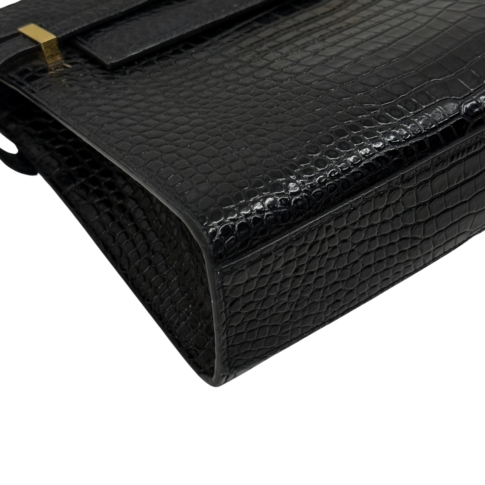 Black croc-embossed leather handbag corner with glossy finish