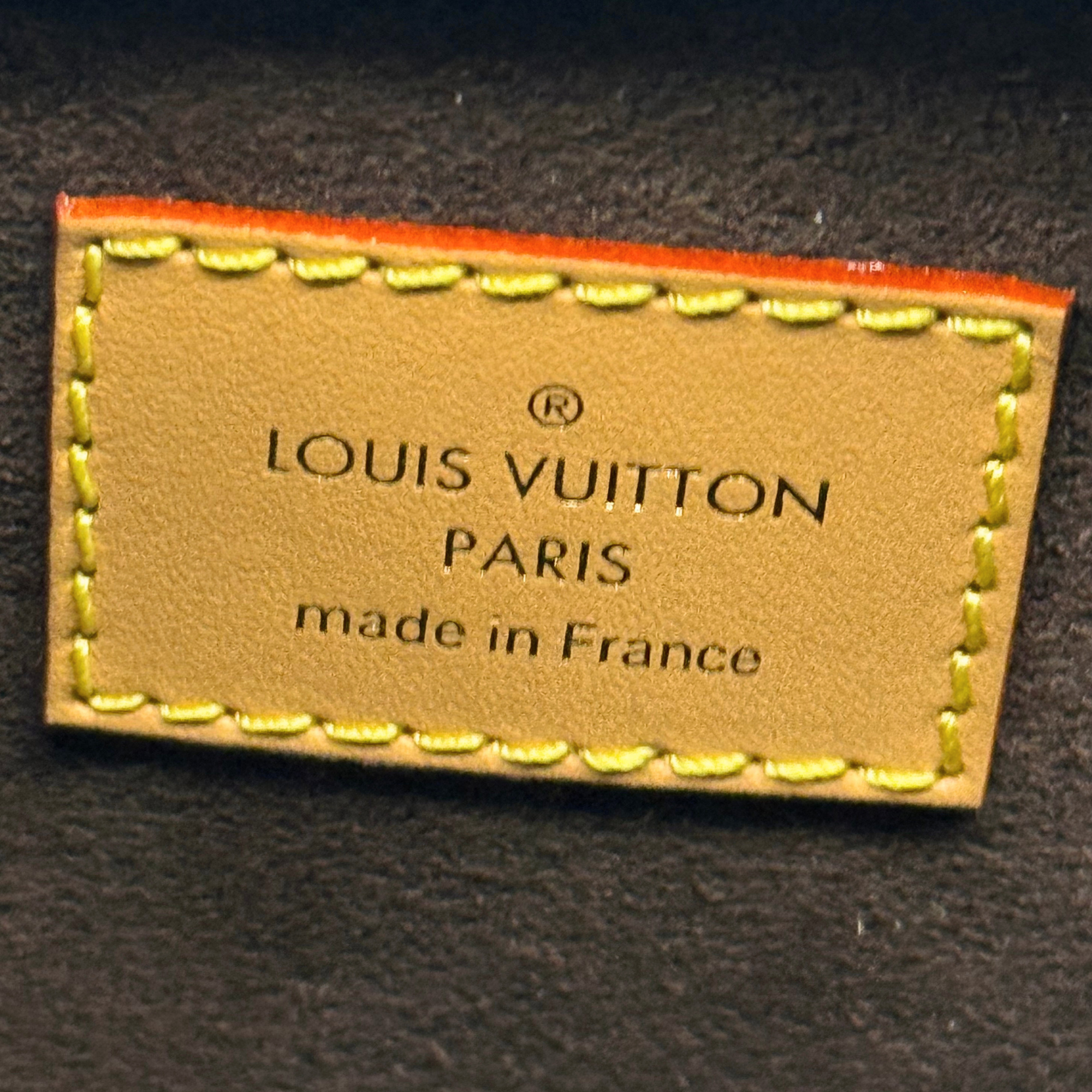 Louis Vuitton Paris leather label on dark fabric with stitched edge