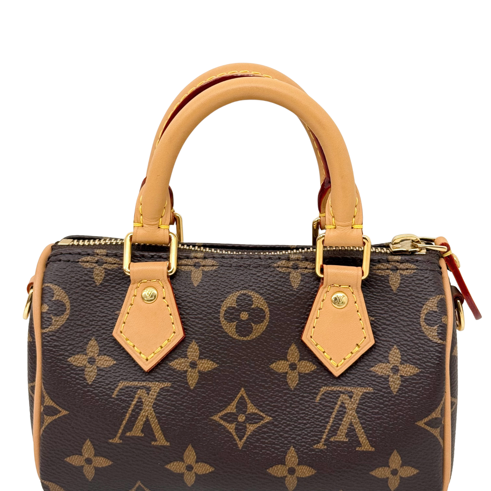 Monogram handbag with tan leather handles, zip top, gold-tone hardware