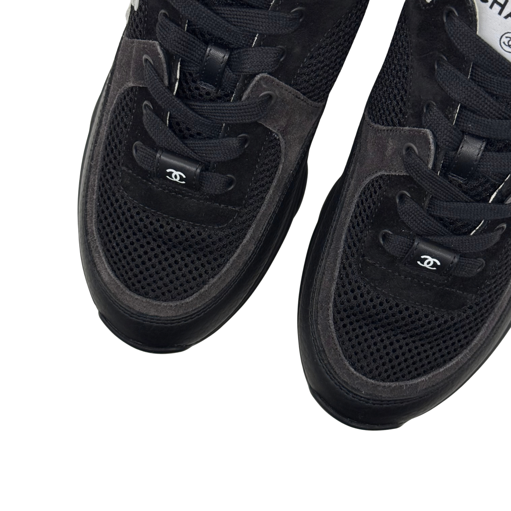 Black sneaker uppers with perforated mesh toe and Chanel logo on strap.