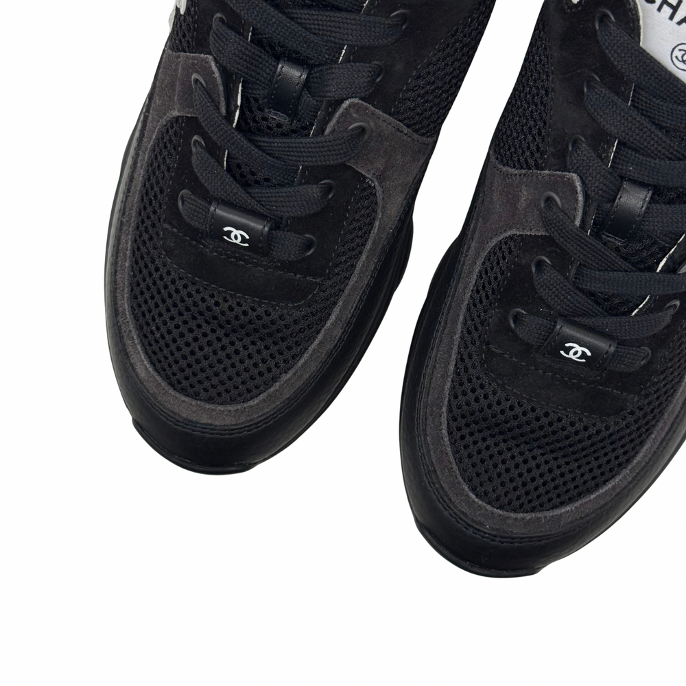 Black sneaker uppers with perforated mesh toe and Chanel logo on strap.