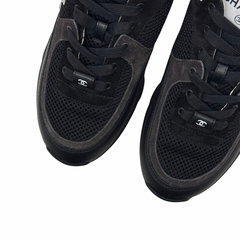 Black sneaker uppers with perforated mesh toe and Chanel logo on strap.