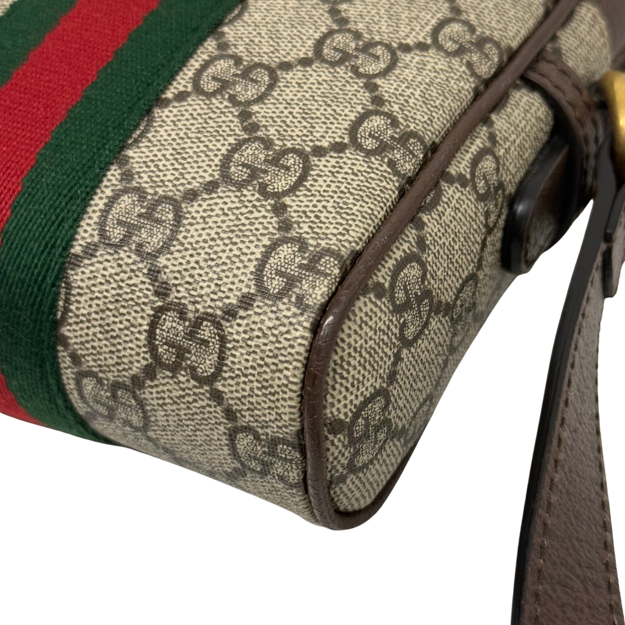 Gucci GG canvas bag corner with vertical green and red stripe and brown leather side trim