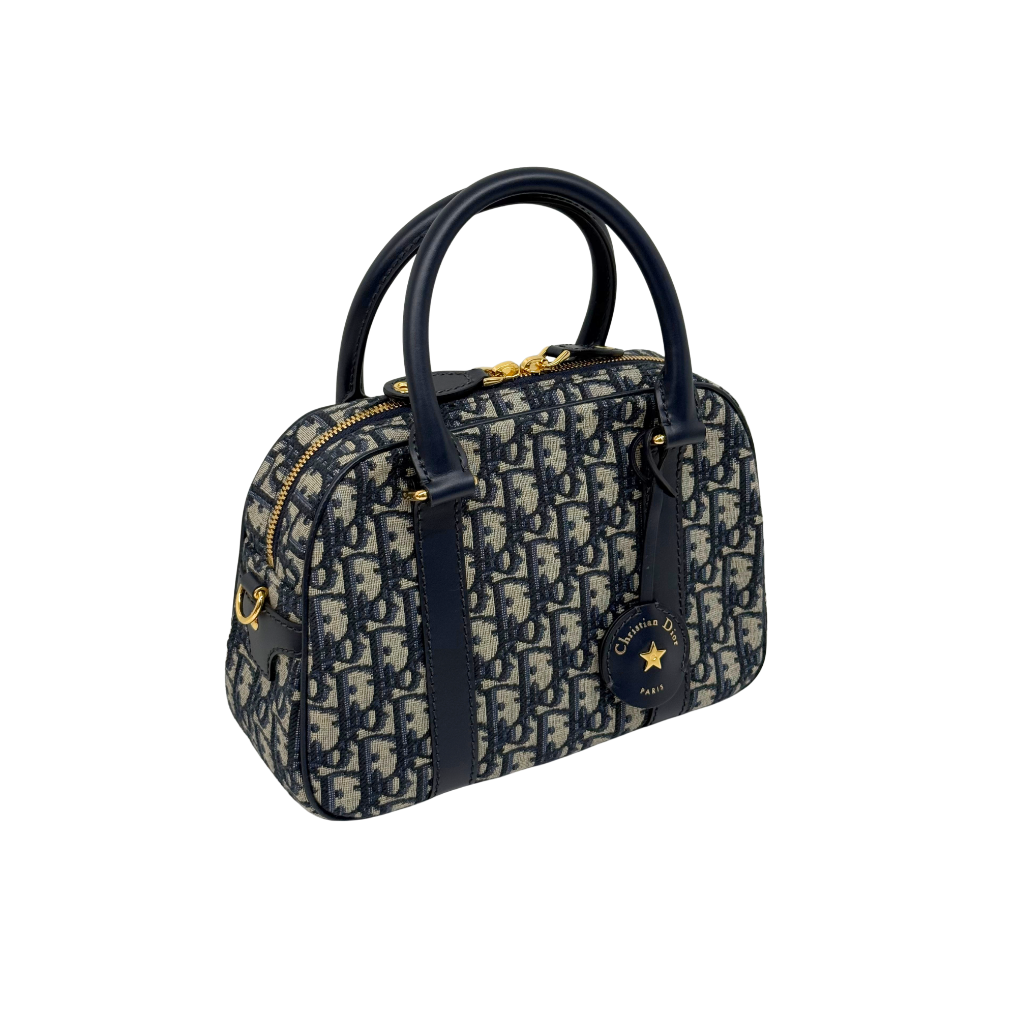 Dior canvas duffel bag with navy leather trim, top handles, and gold hardware