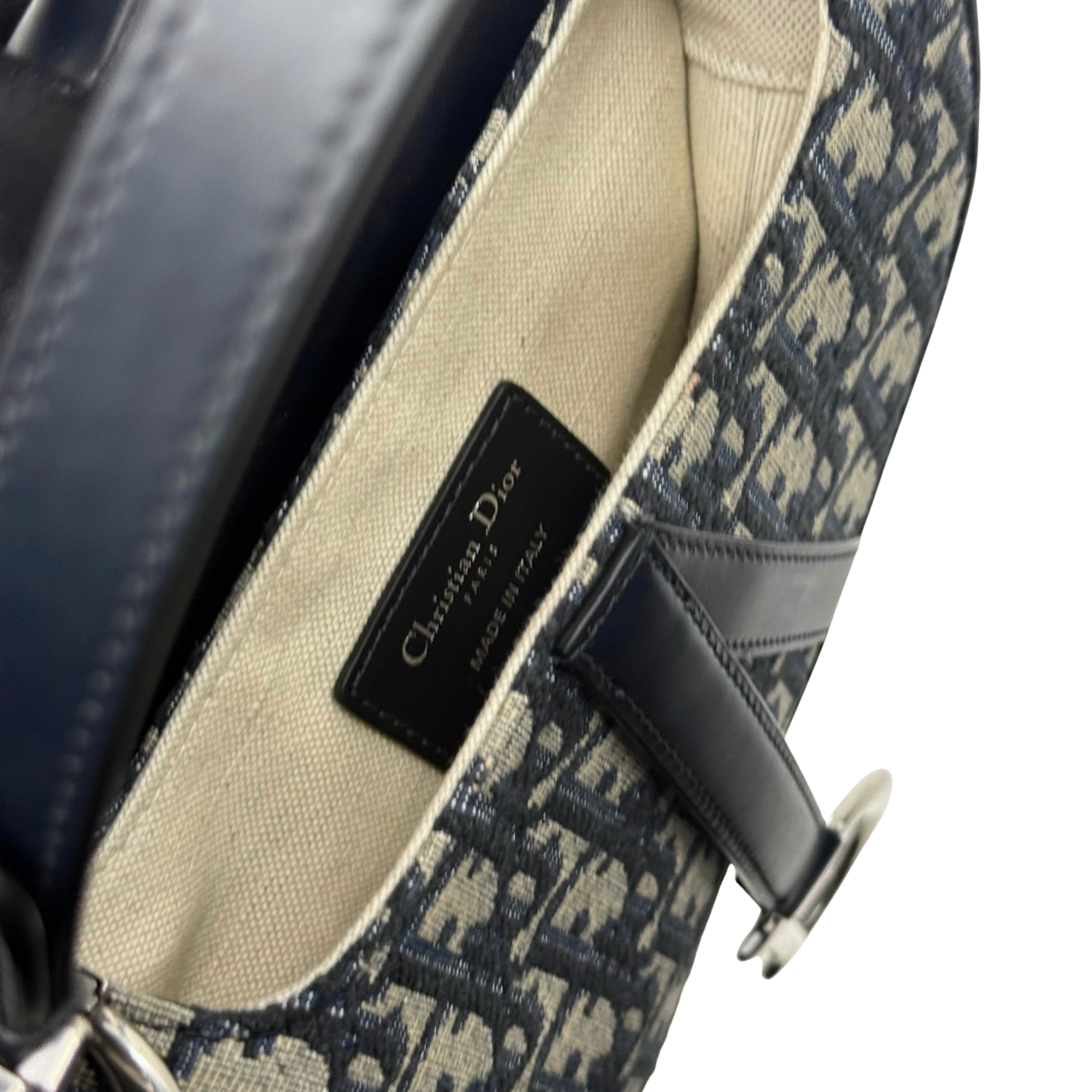 Pre-owned Dior crossbody bag interior with black fabric label and patterned lining