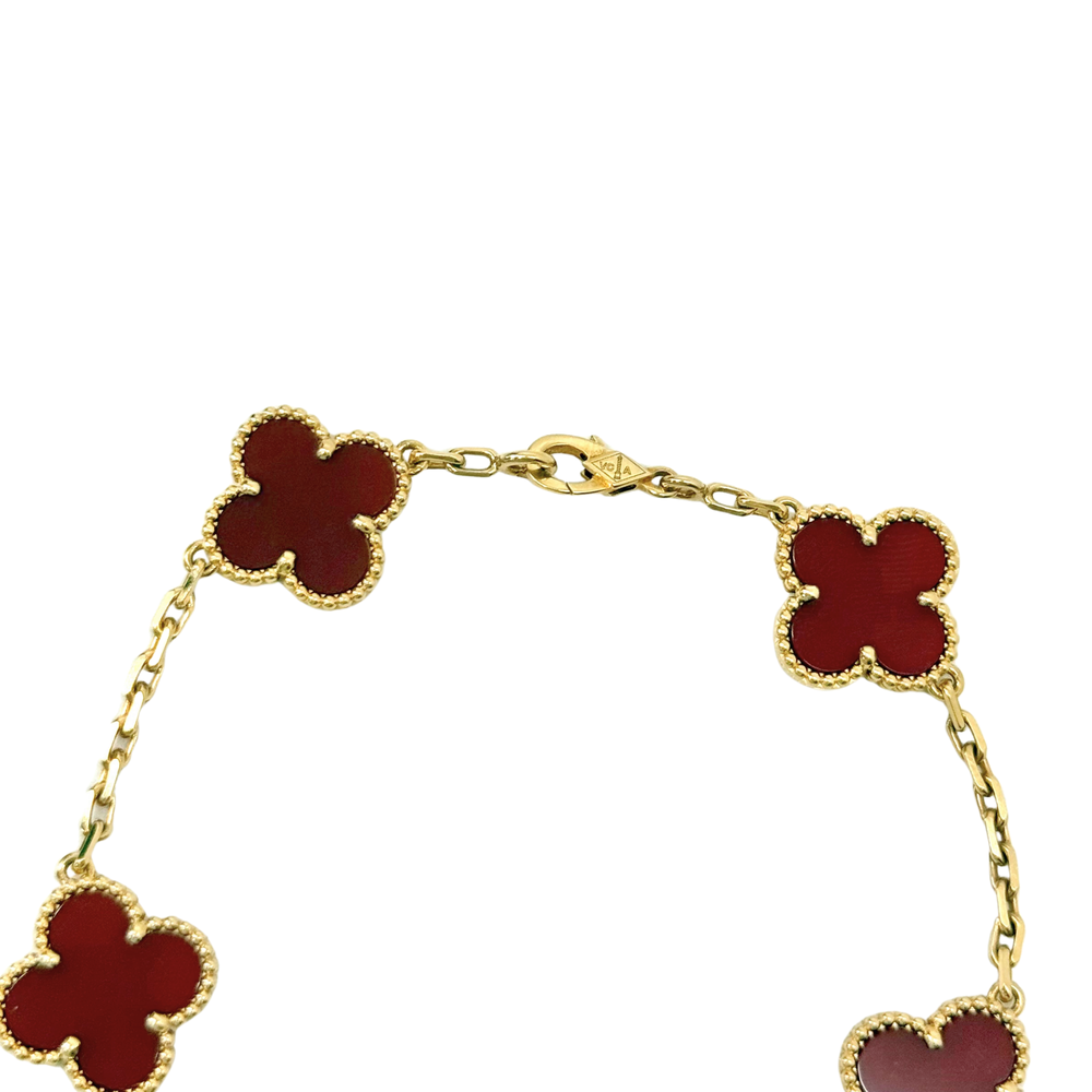 Goldtone bracelet with red clover links, side close-up