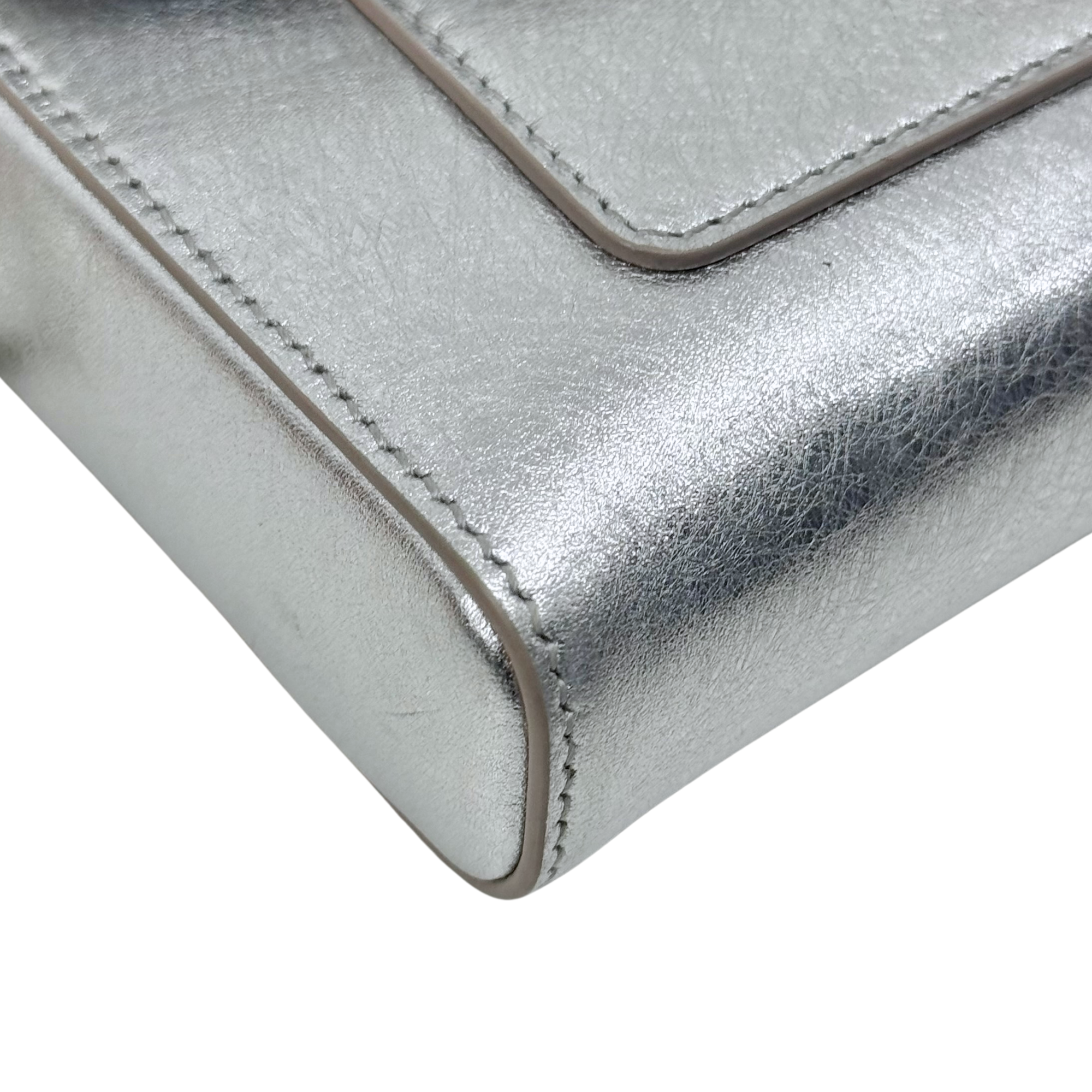 Pre-owned Bulgari silver metallic leather corner with visible edge seam stitching detail