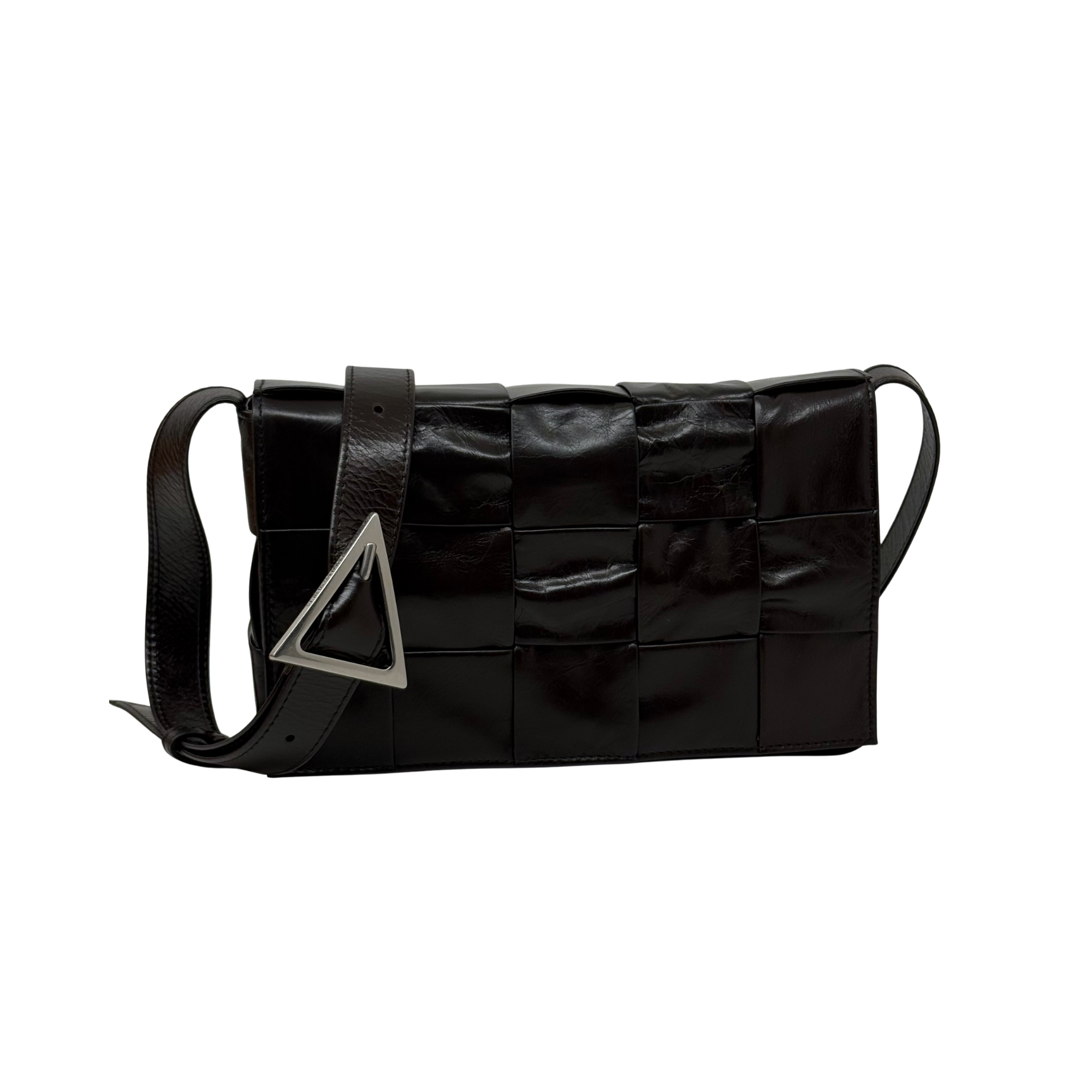 Black quilted leather crossbody bag with triangular metal logo and shoulder strap