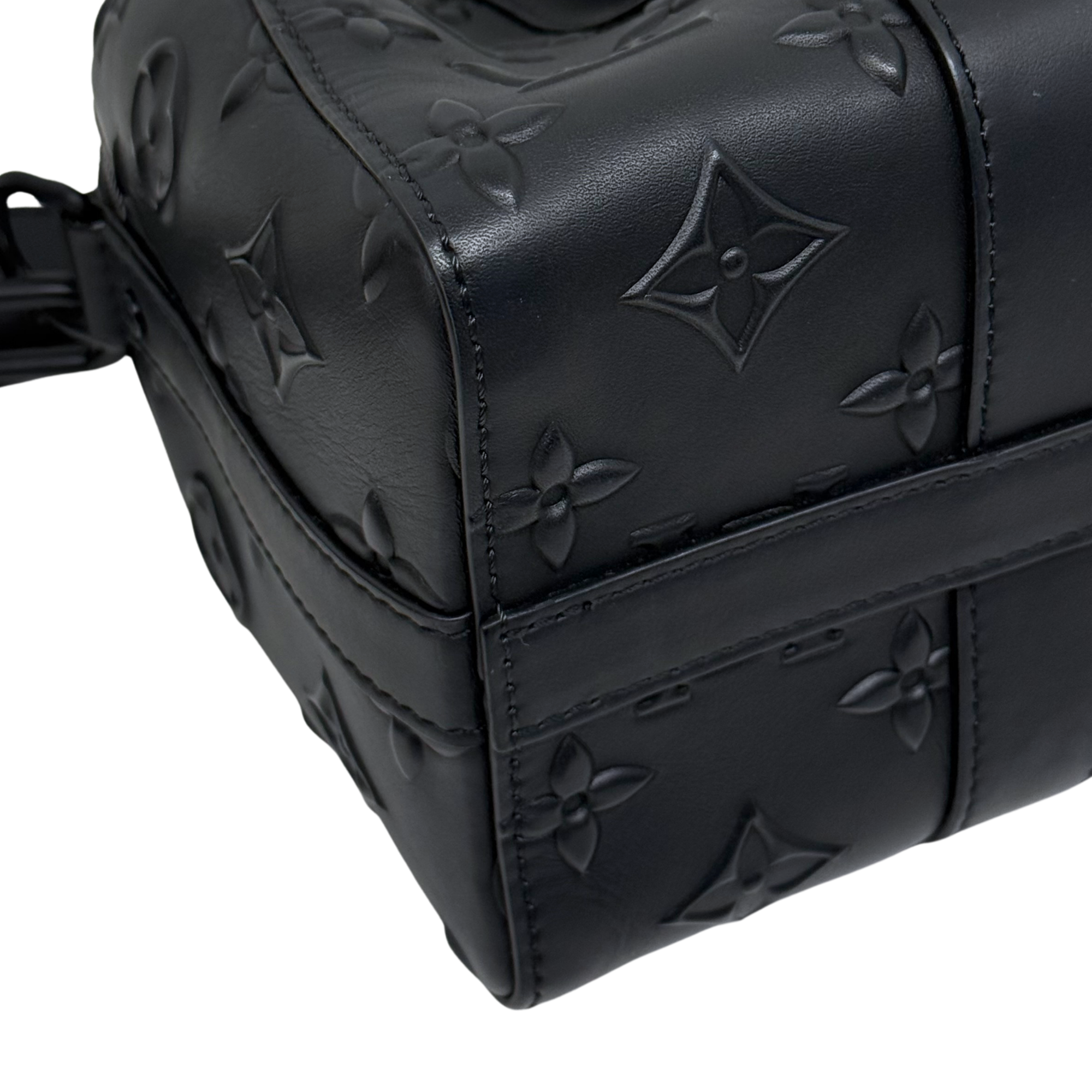 Black Louis Vuitton monogram crossbody bag with embossed motifs and shoulder strap