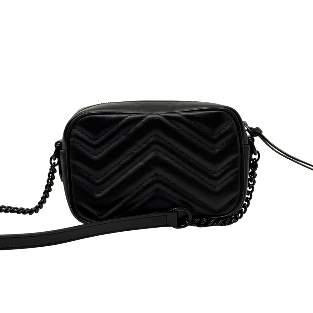 Black leather crossbody bag with chevron stitching and chain strap, front view.