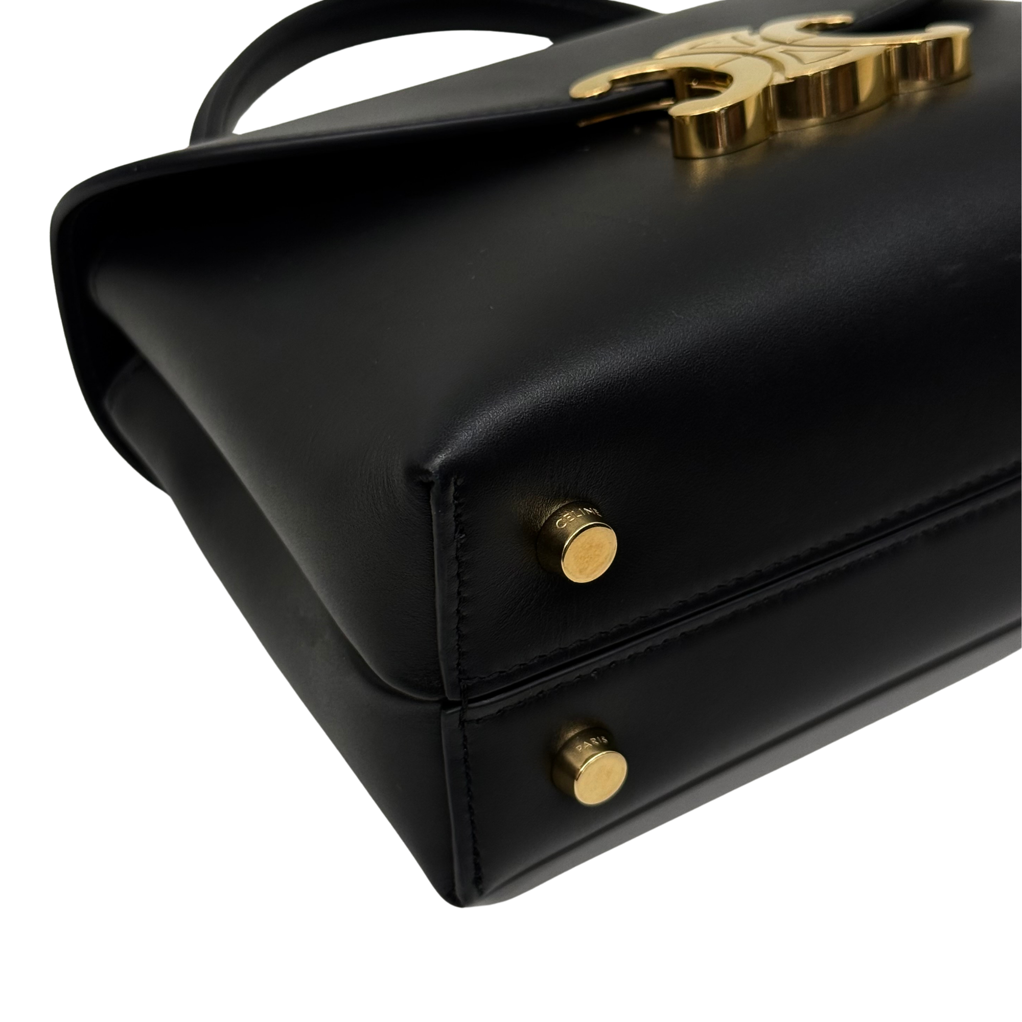Black leather flap bag corner with gold-tone C logo and snap closure