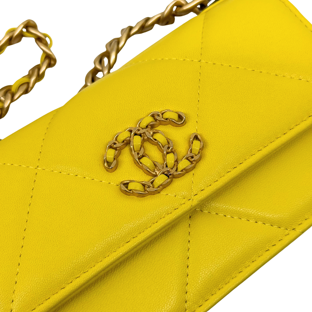 Yellow quilted leather flap with gold chain clasp and stitched panels