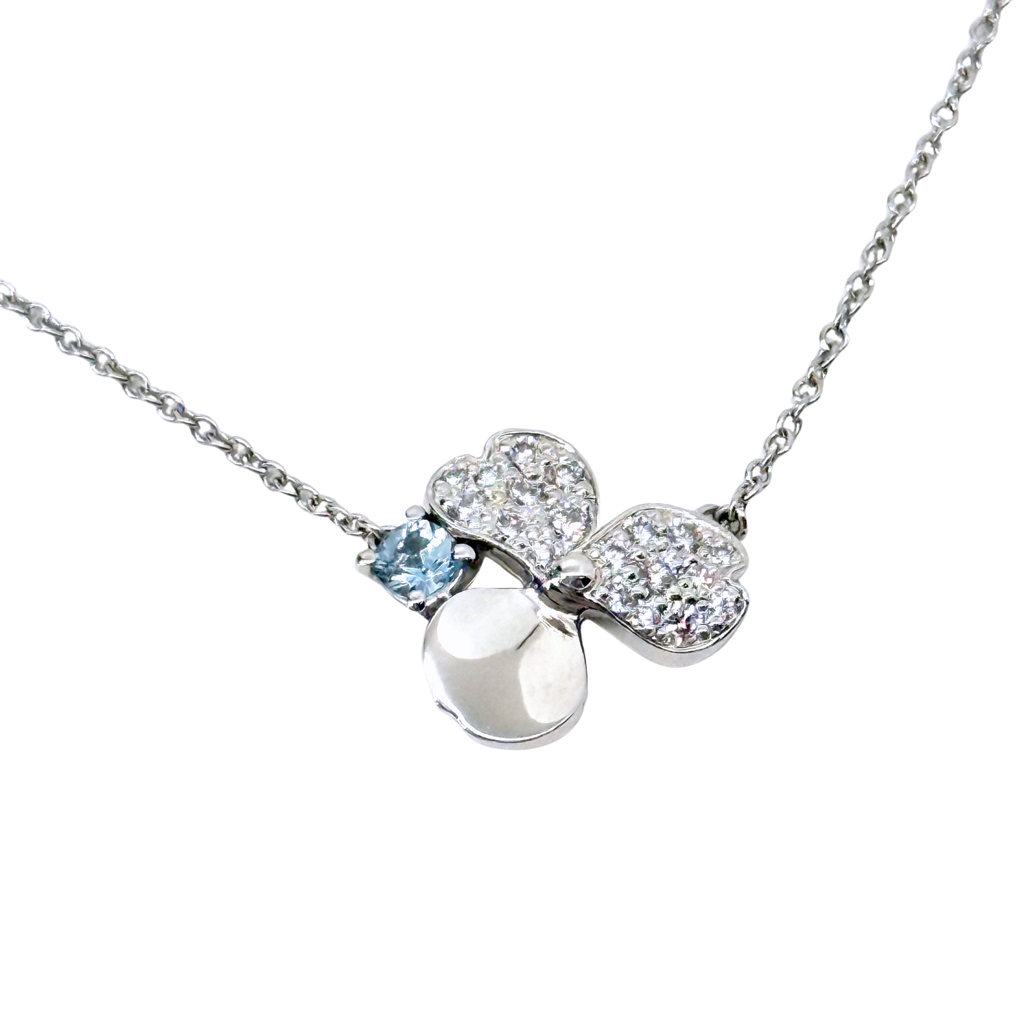 Clover pendant necklace close-up with silver-tone bell shape and blue accent gemstone
