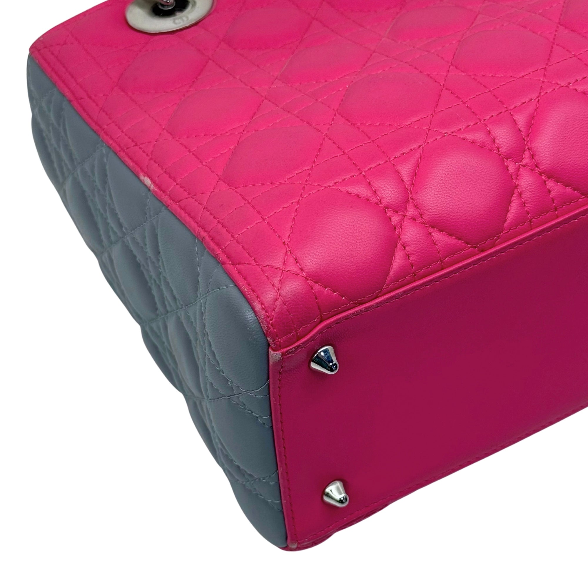 Quilted tote bag corner with magenta front, gray side panels, silver studs