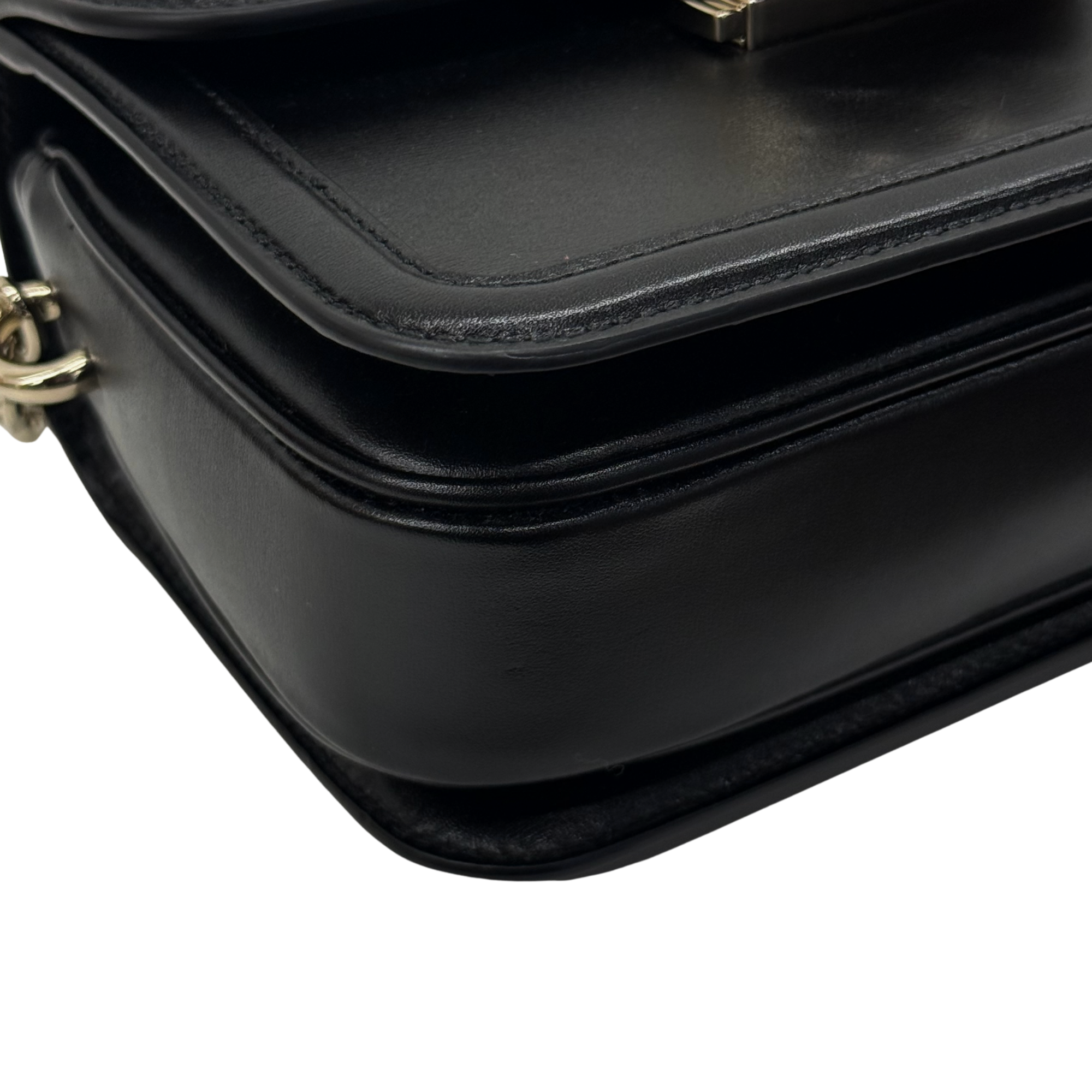 Black leather bag corner with layered panel seam stitching