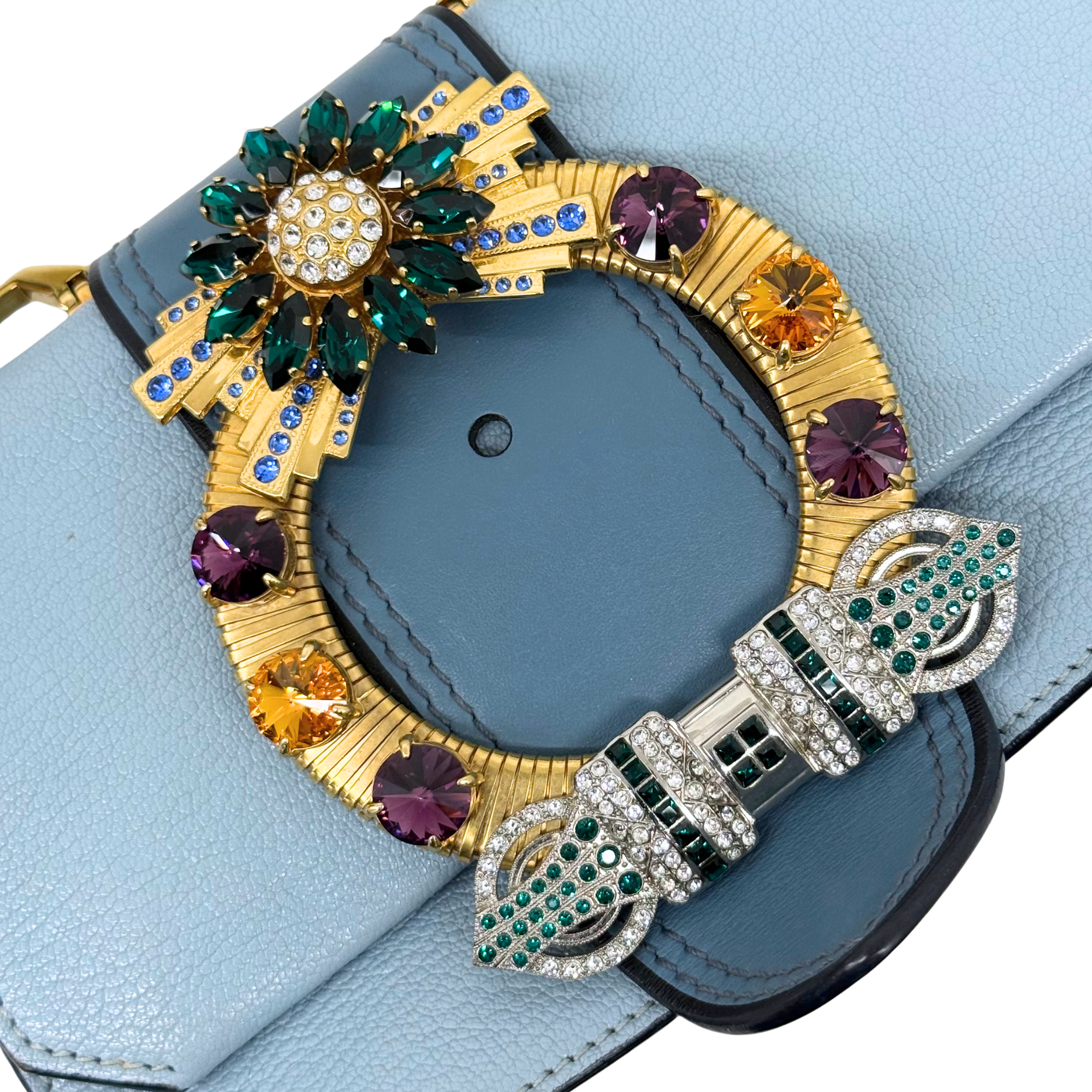 Jeweled front clasp embellishment on light blue leather flap