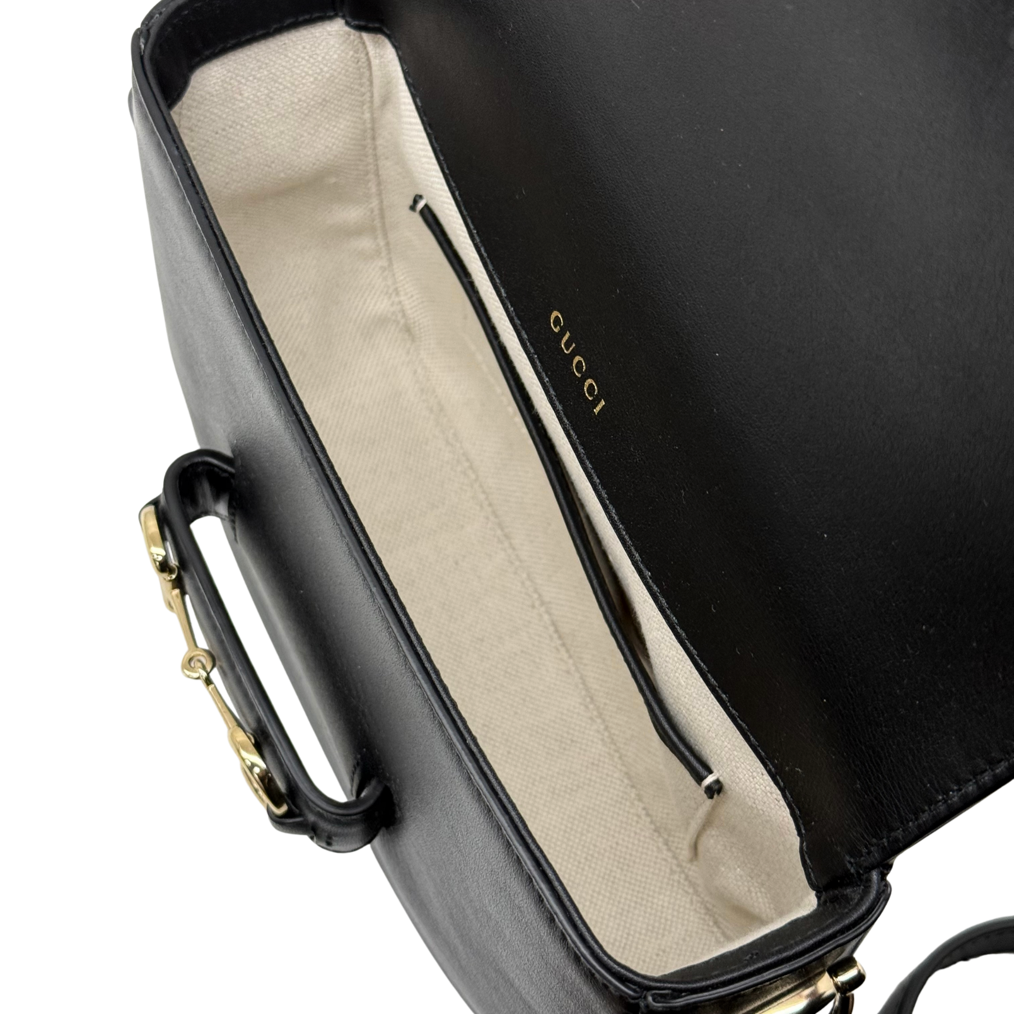 Gucci black leather bag interior with beige lining and zipper pocket