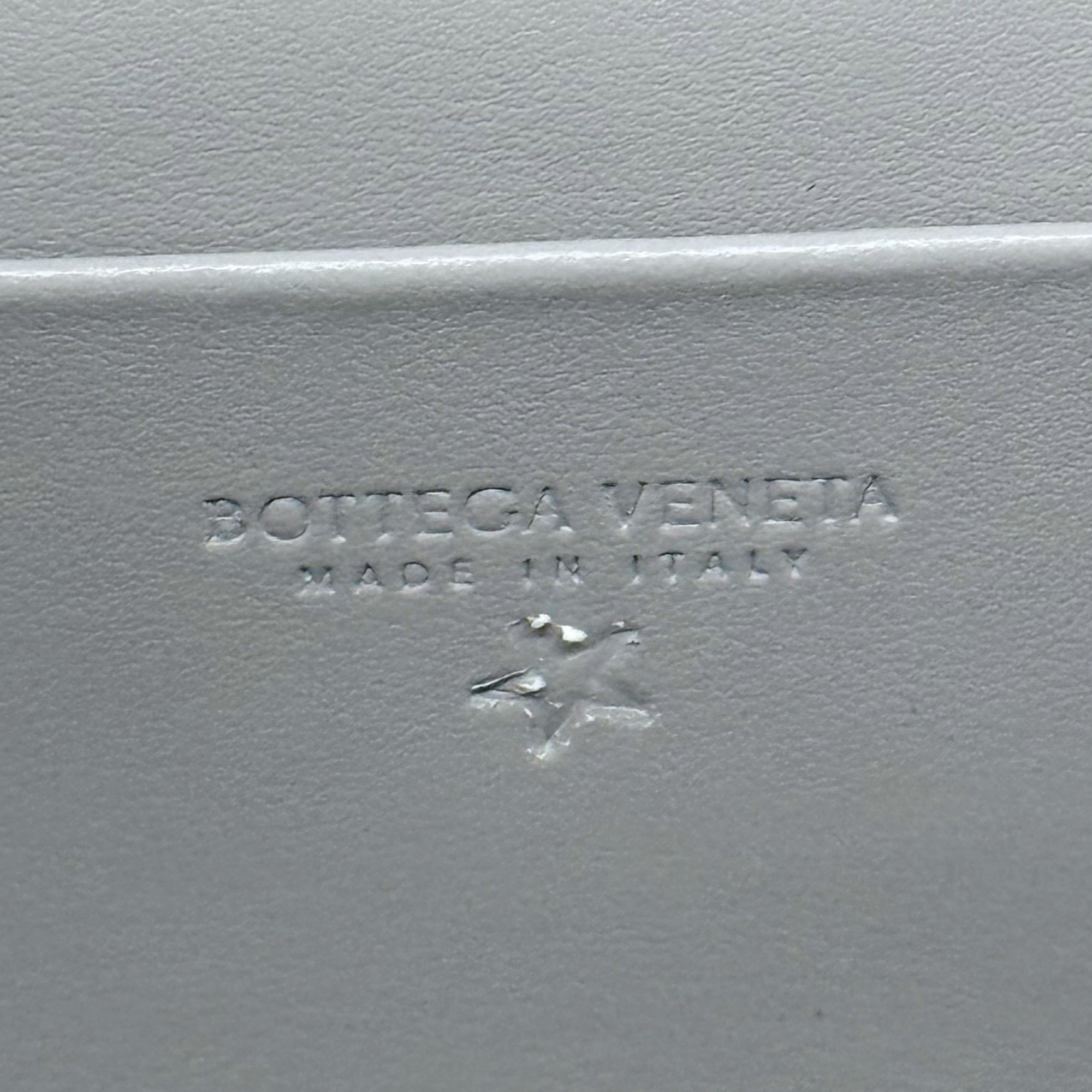Bottega Veneta gray leather embossed mark reading "Made in Italy".