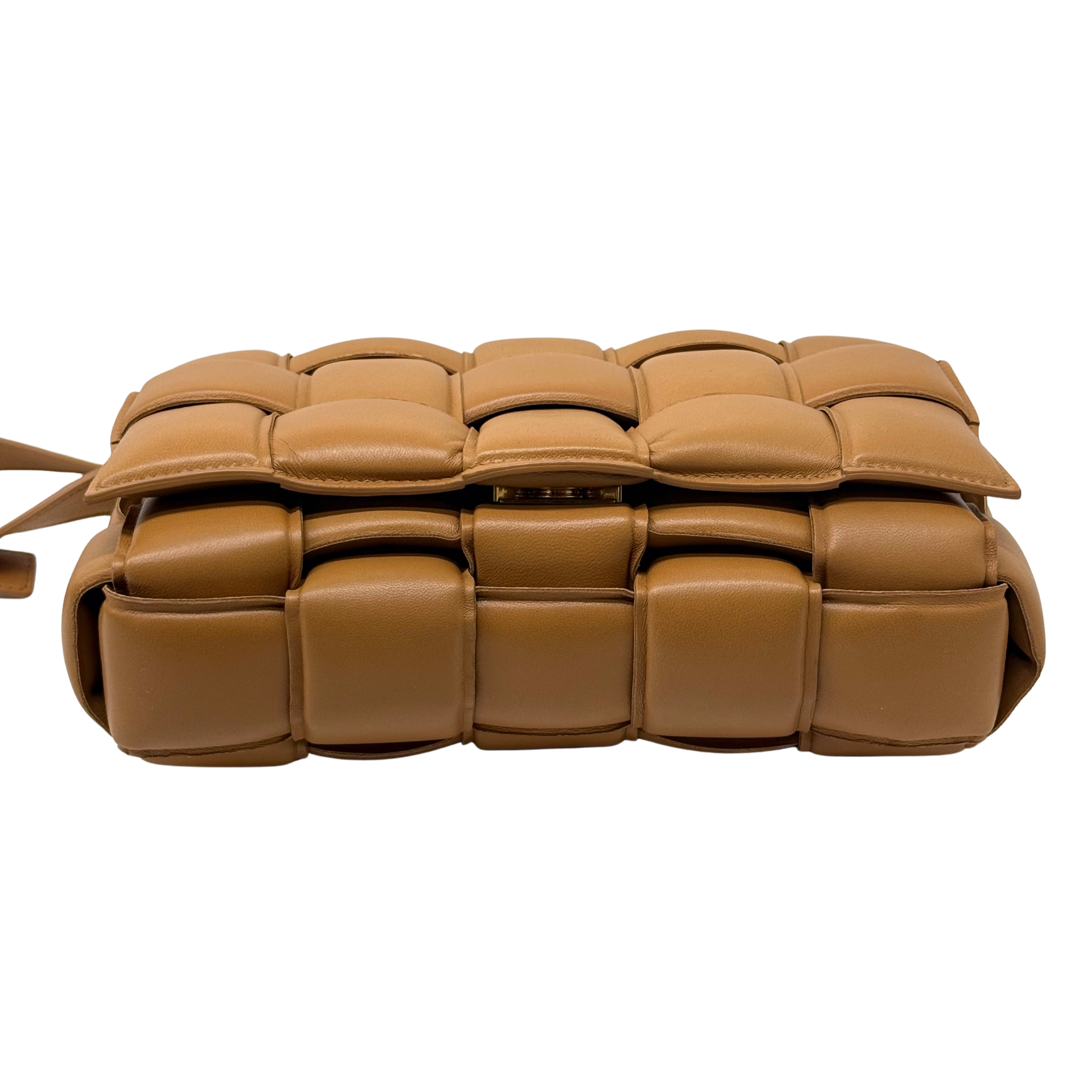 Tan quilted leather crossbody bag with padded cassette-style panels and zipper closure
