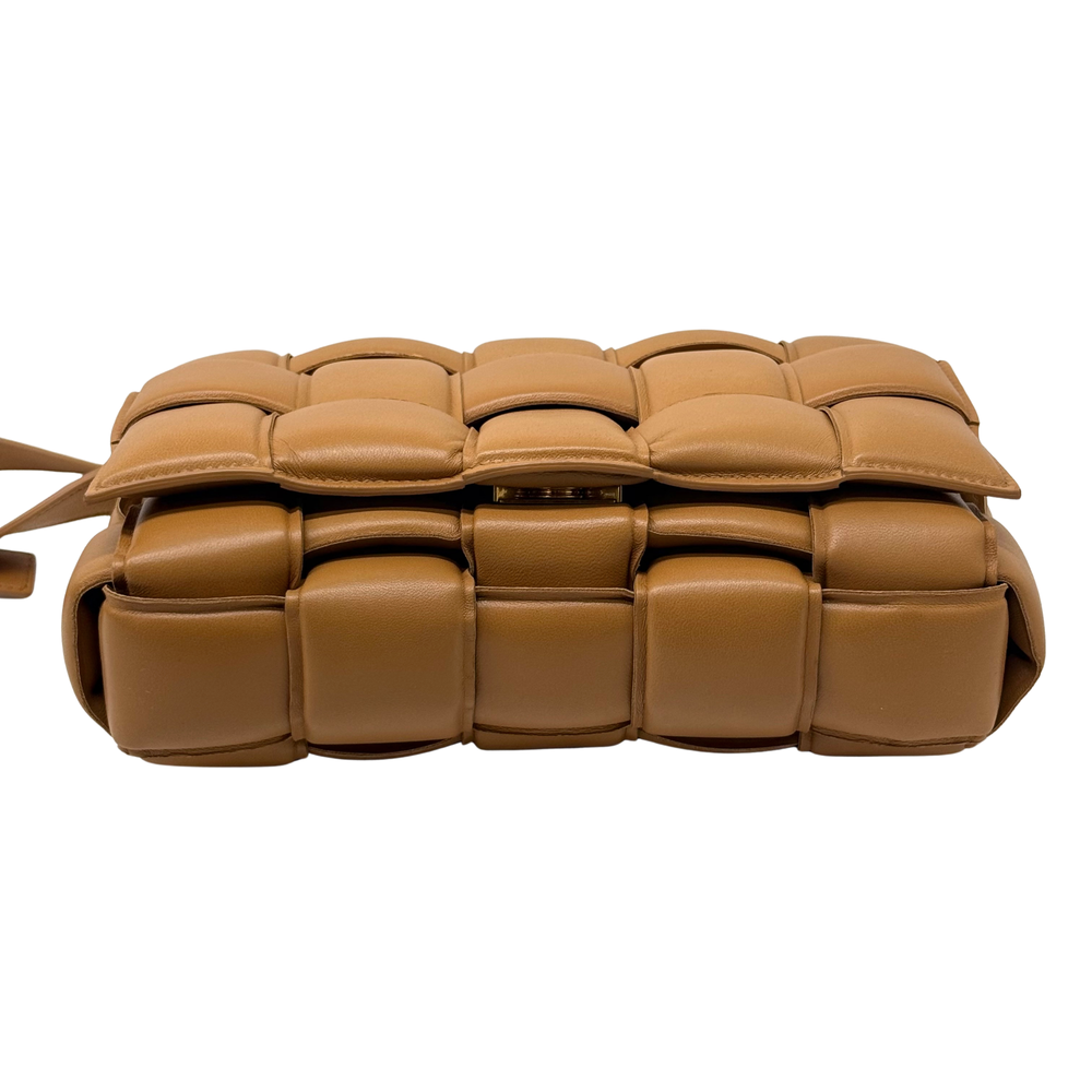 Tan quilted leather crossbody bag with padded cassette-style panels and zipper closure