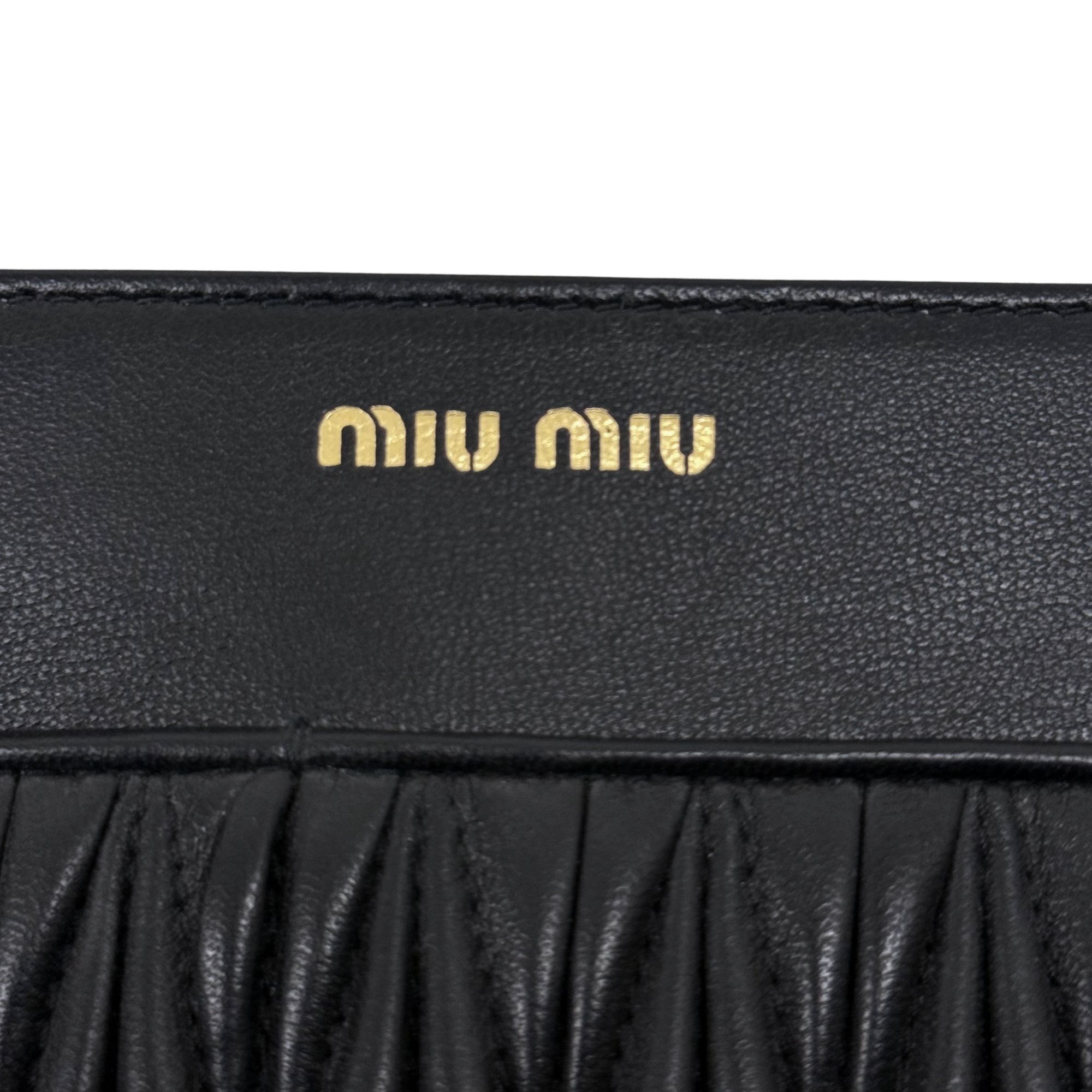 Miu Miu black leather flap with embossed gold logo detail