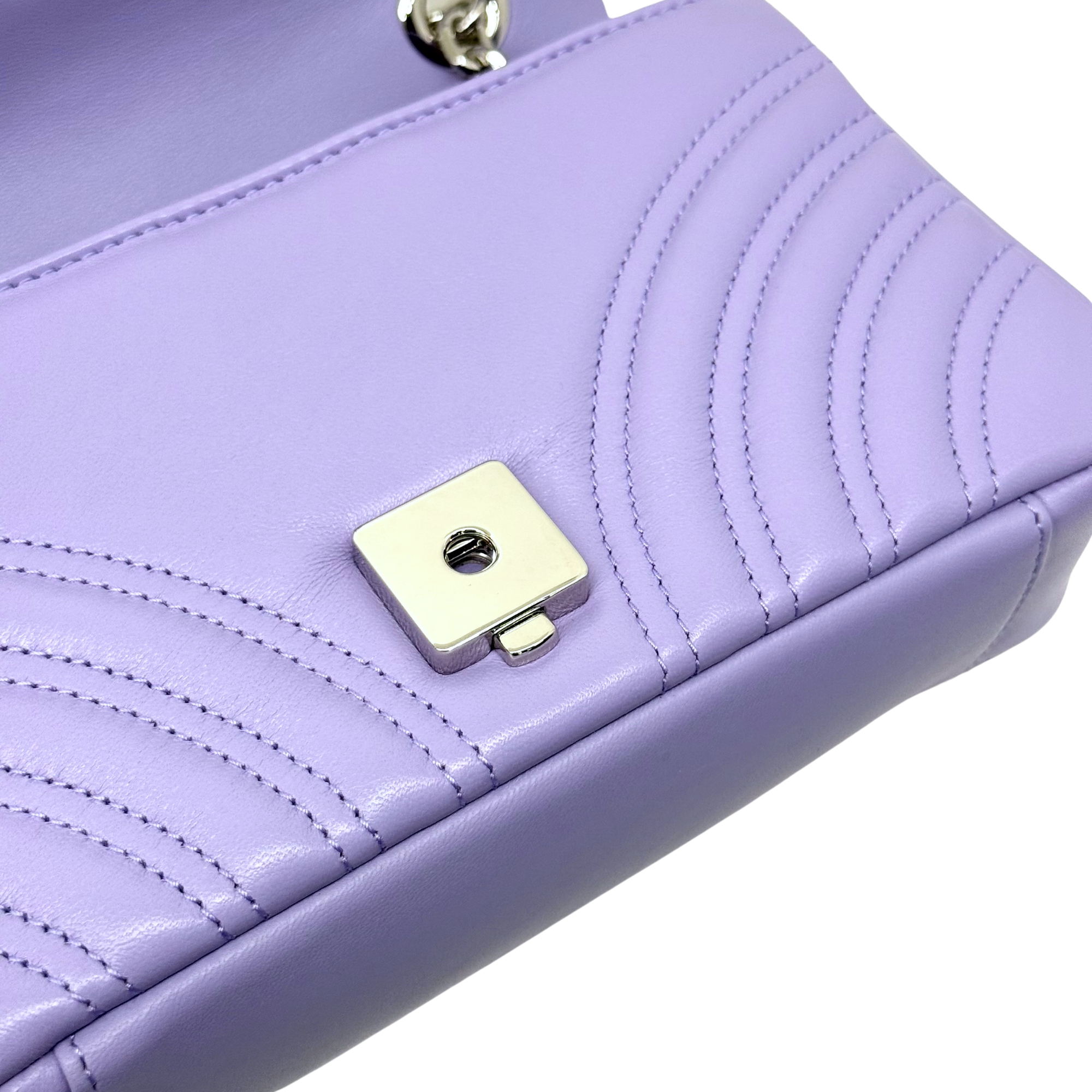 Lavender quilted bag front with gold-tone square snap plate and stitched chevron lines