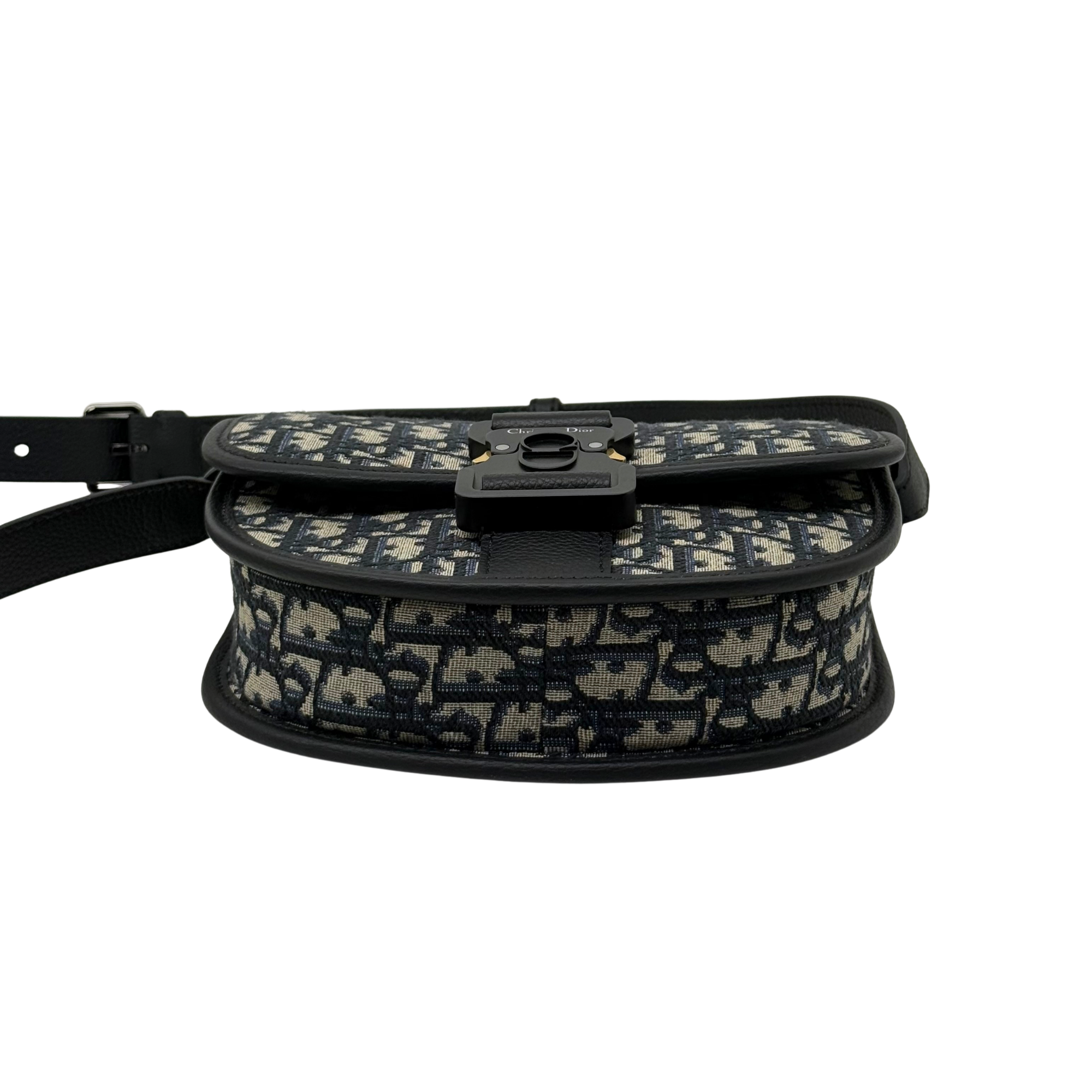 Dior mini crossbody bag with patterned canvas flap, buckle hardware, and strap