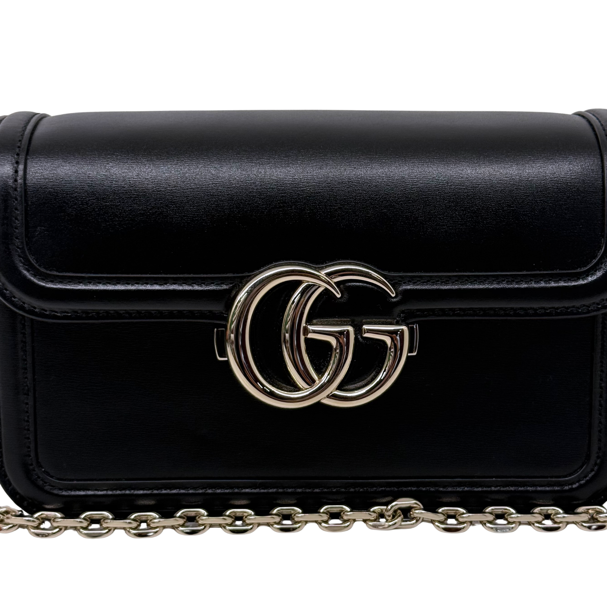 Black leather shoulder bag front with gold-tone GG logo and chain