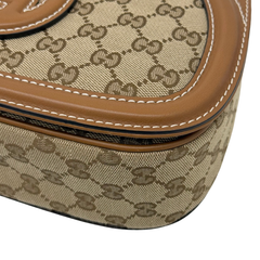 Gucci GG canvas bag corner closeup with brown leather piping and contrast stitching