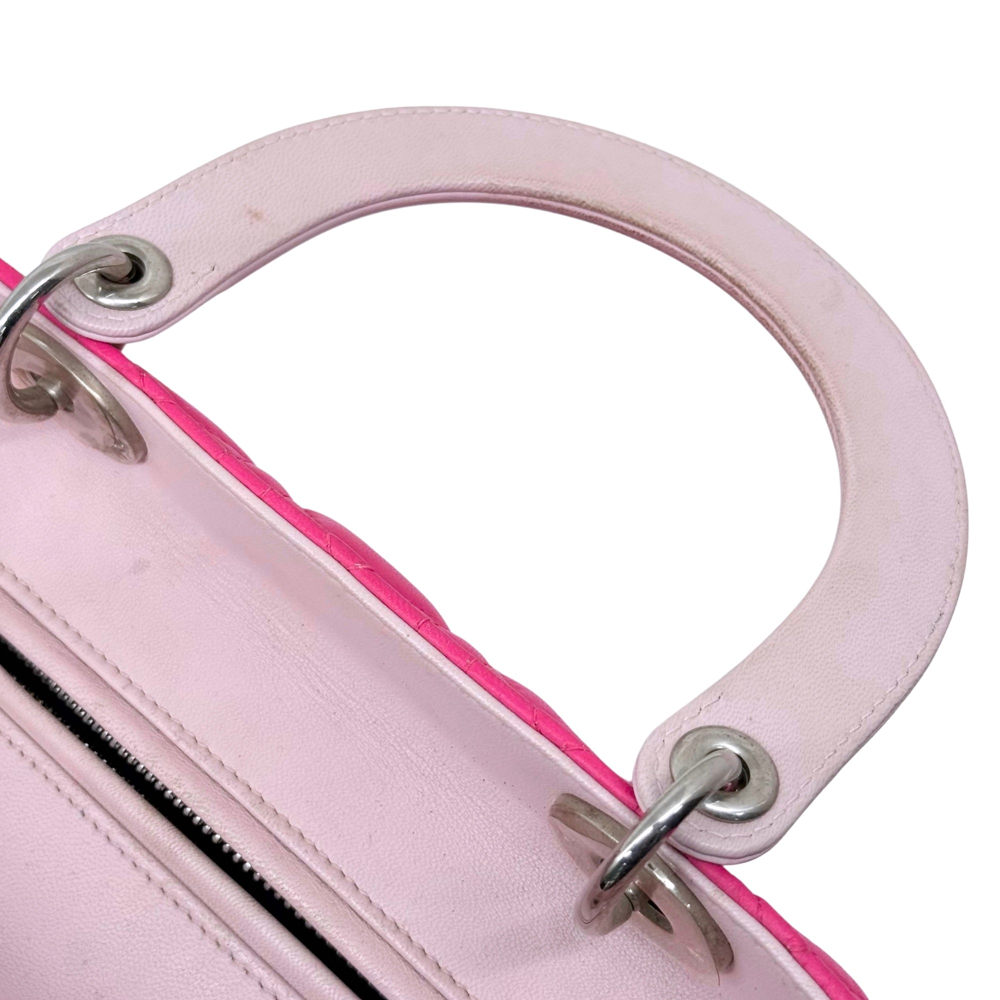 Quilted tote bag side handle with silver hardware and zipper opening, pink interior