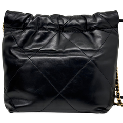 Black quilted mini crossbody bag front with diamond stitching and textured leather.