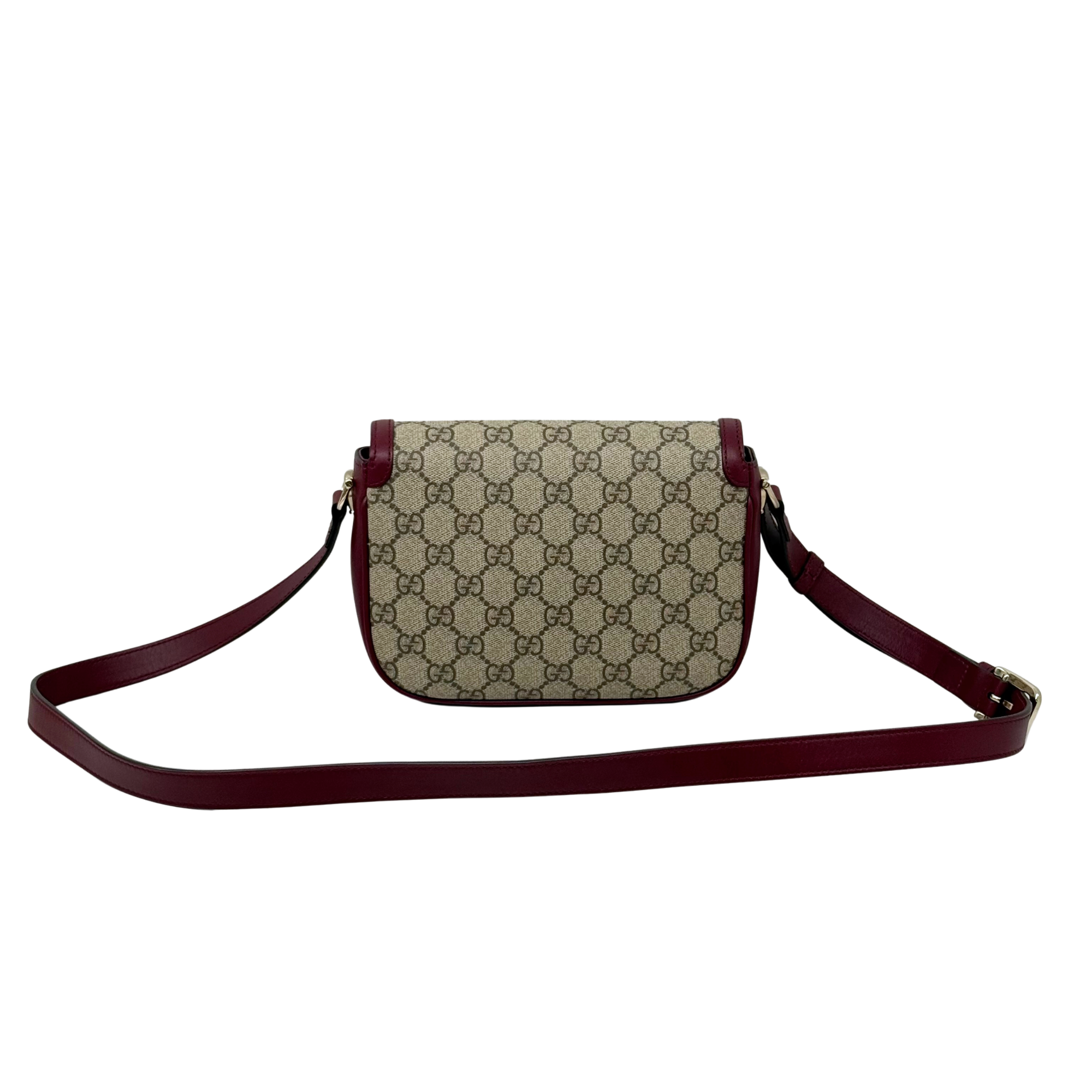 Gucci small GG crossbody bag with burgundy leather strap and flap buckle