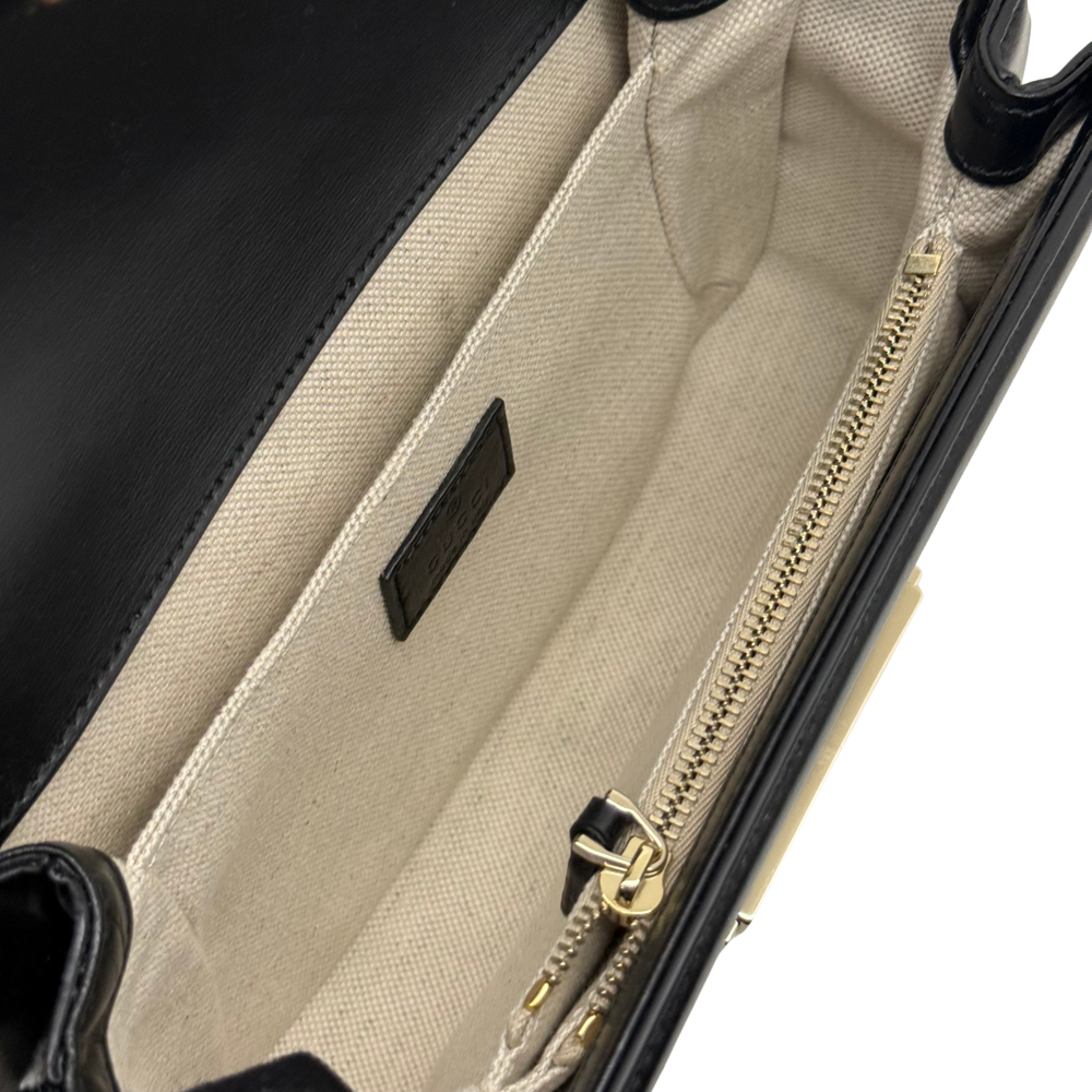 Beige fabric-lined interior with zipper and leather logo patch