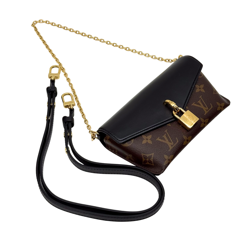 Monogram crossbody bag with black flap, gold clasp, and chain shoulder strap