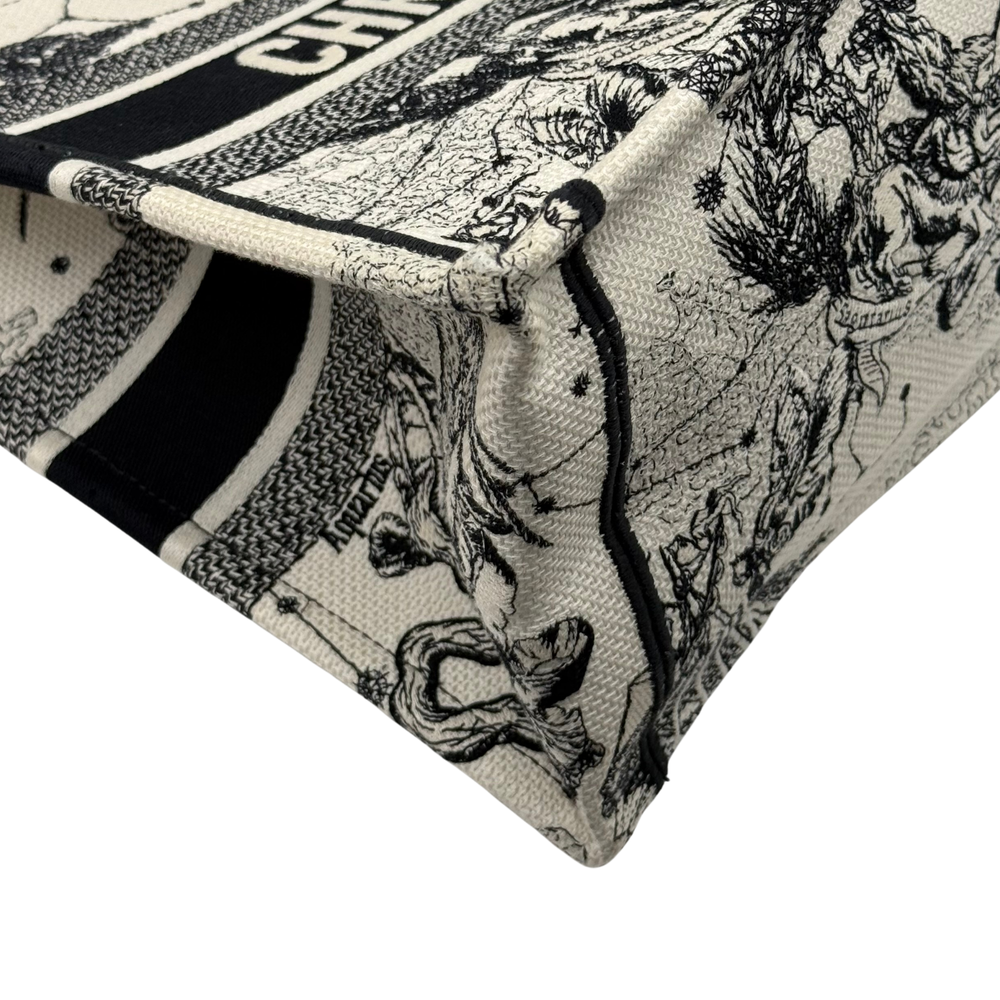 Dior canvas tote bag corner detail with black piping and stitched fabric edge