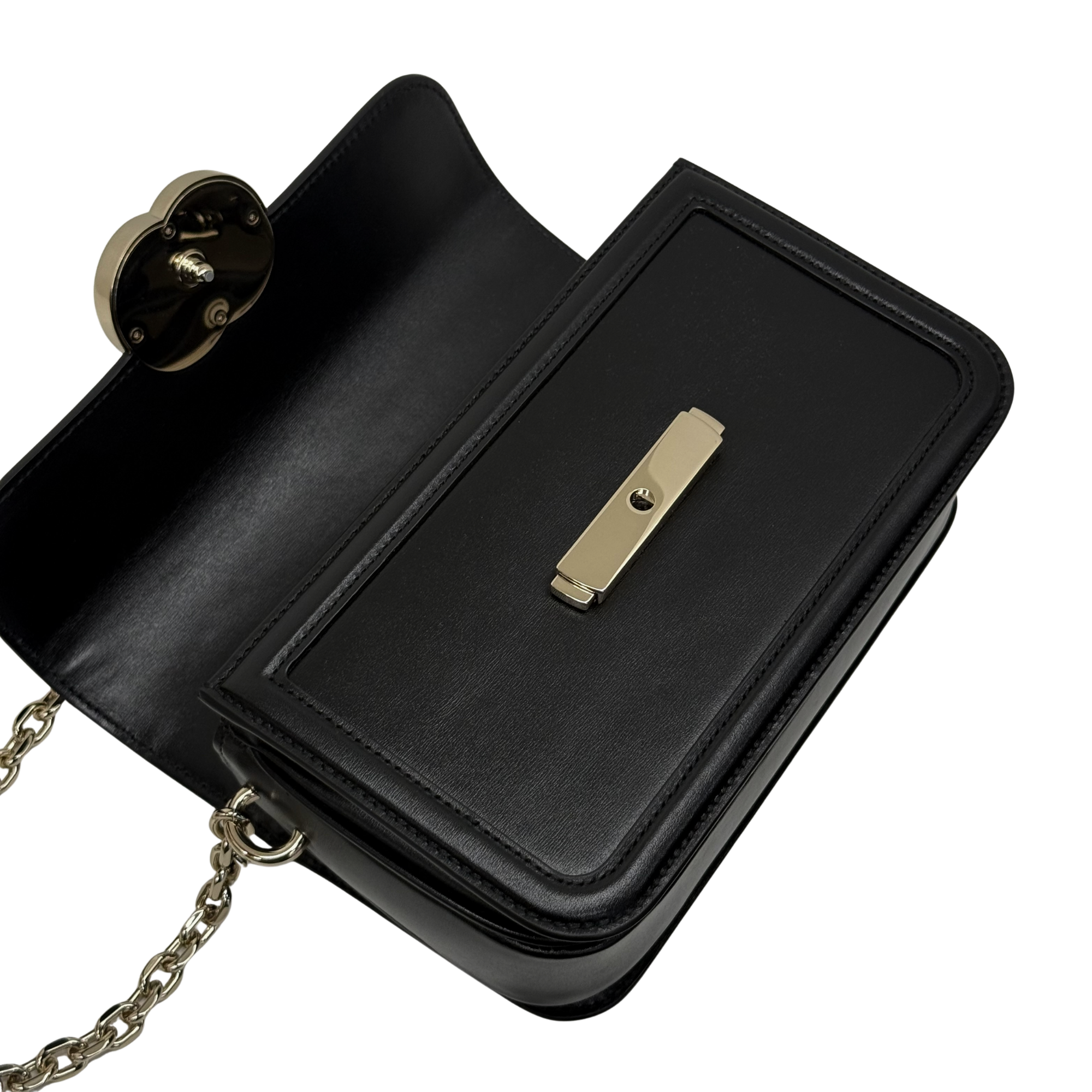 Black leather shoulder bag open flap with gold-tone chain and interior panel