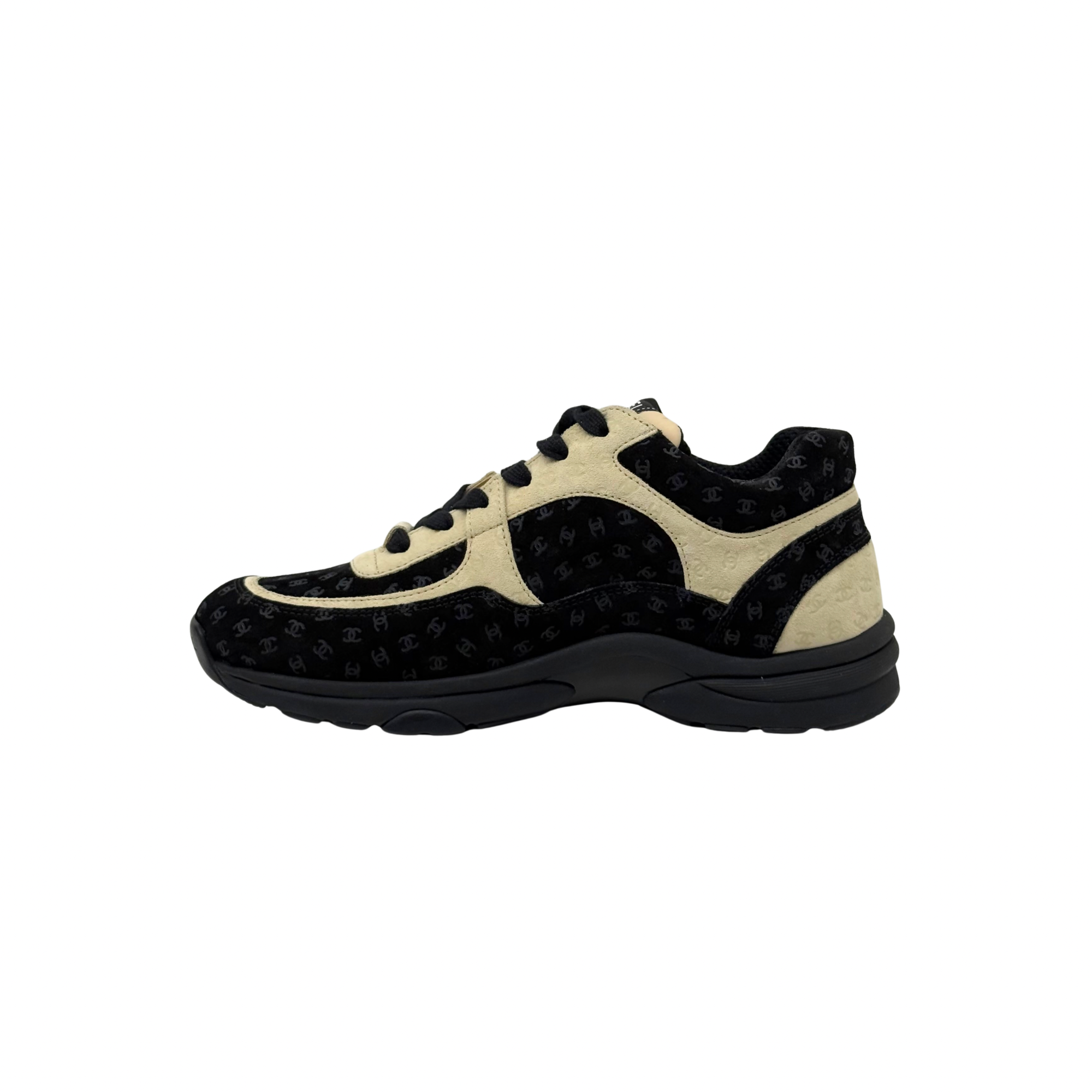 Black and beige Chanel low-top sneakers with lace-up, rounded toe, and chunky sole