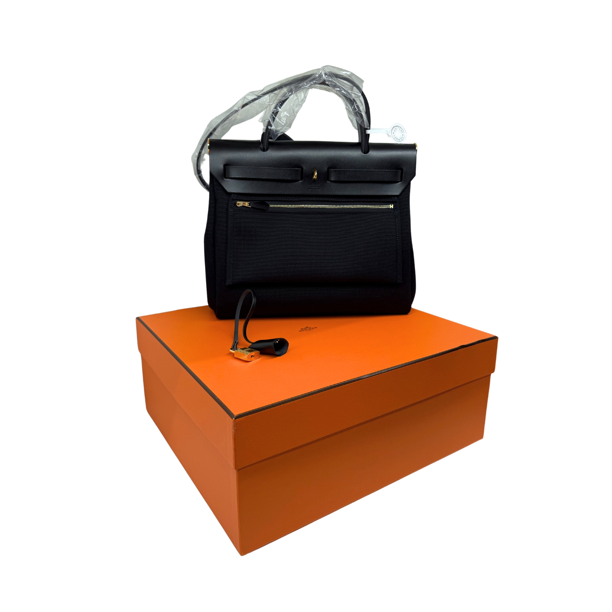 Hermes structured leather handbag, black with top handles, flap and gold hardware, front pocket