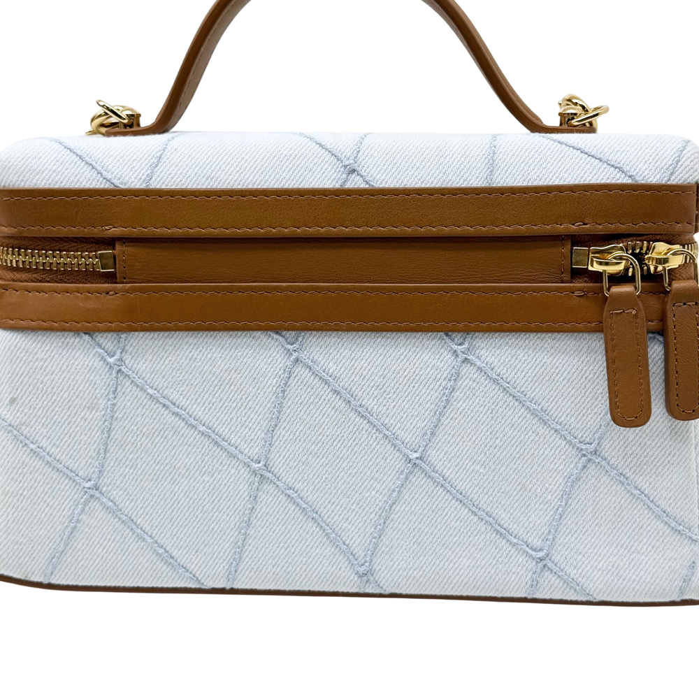 Chanel light-blue quilted front view with brown zip band and hanging zip pulls