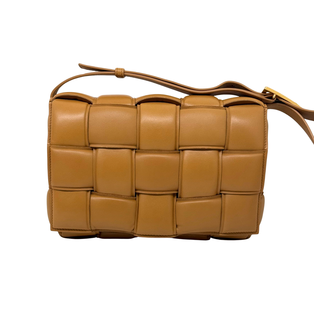 Tan leather shoulder bag with adjustable strap and cassette-style quilted panels